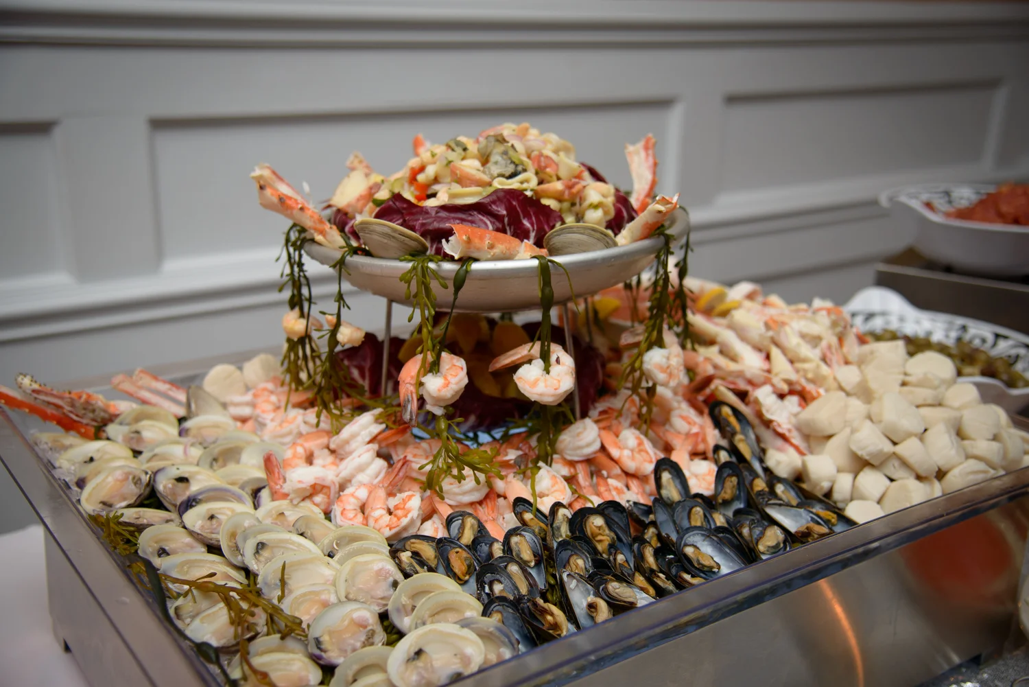 A seafood platter featuring shrimp, clams, and mussels elegantly arranged.