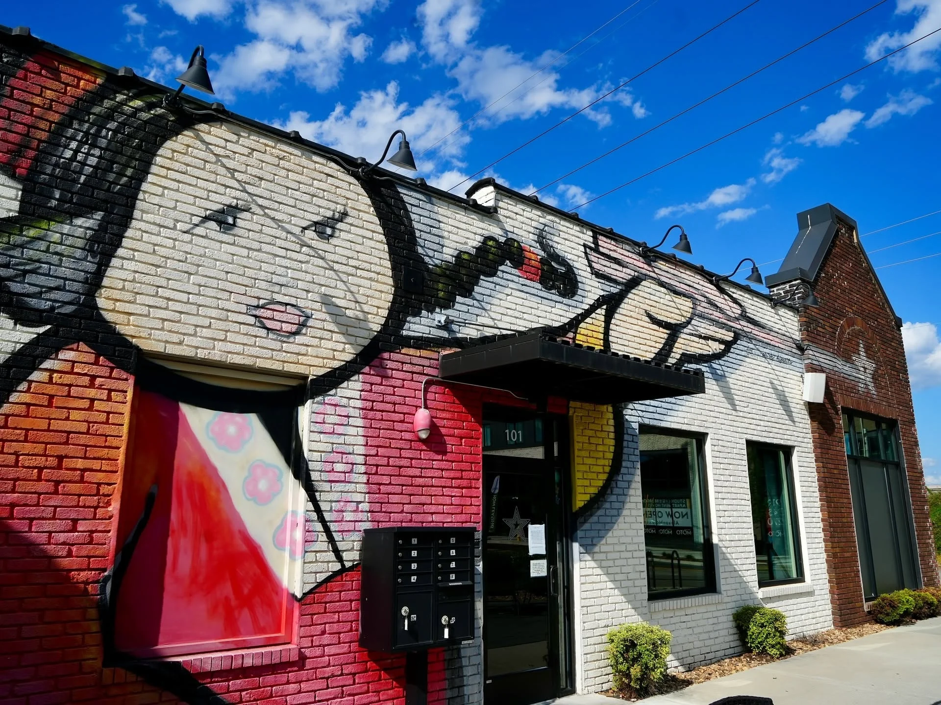 Colorful mural on restaurant exterior featuring a stylized character
