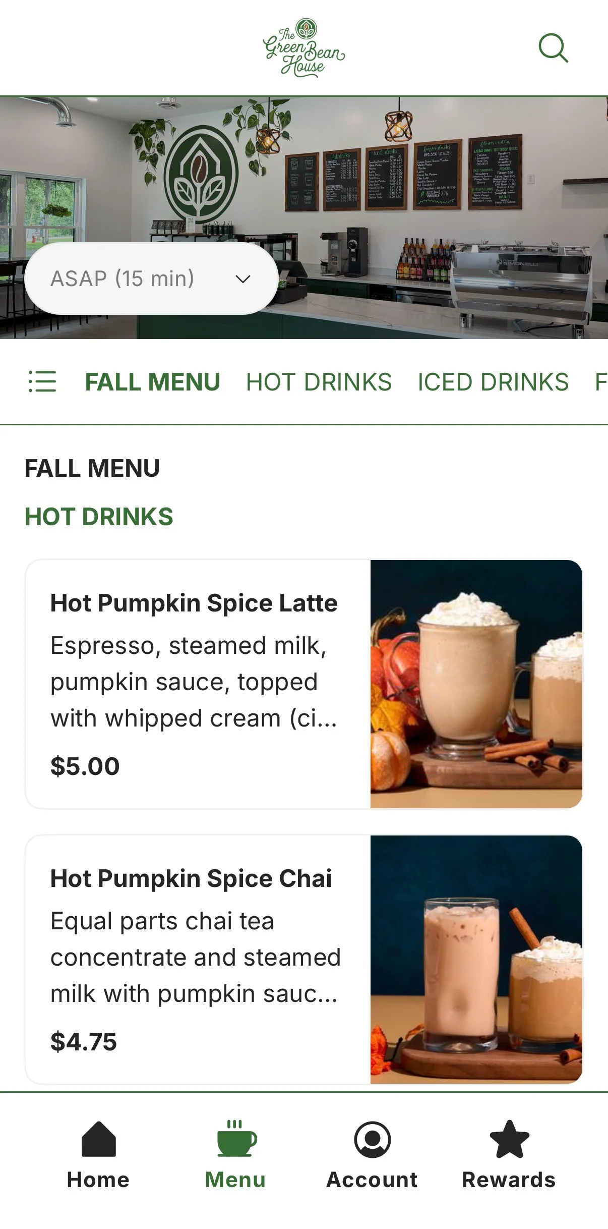 Cozy café interior with green accents and a chalkboard menu