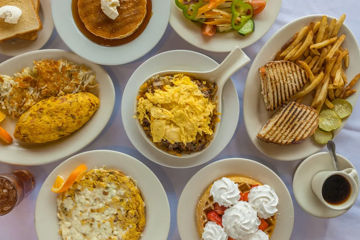Hearty American breakfast platter with eggs, pancakes, and sandwiches