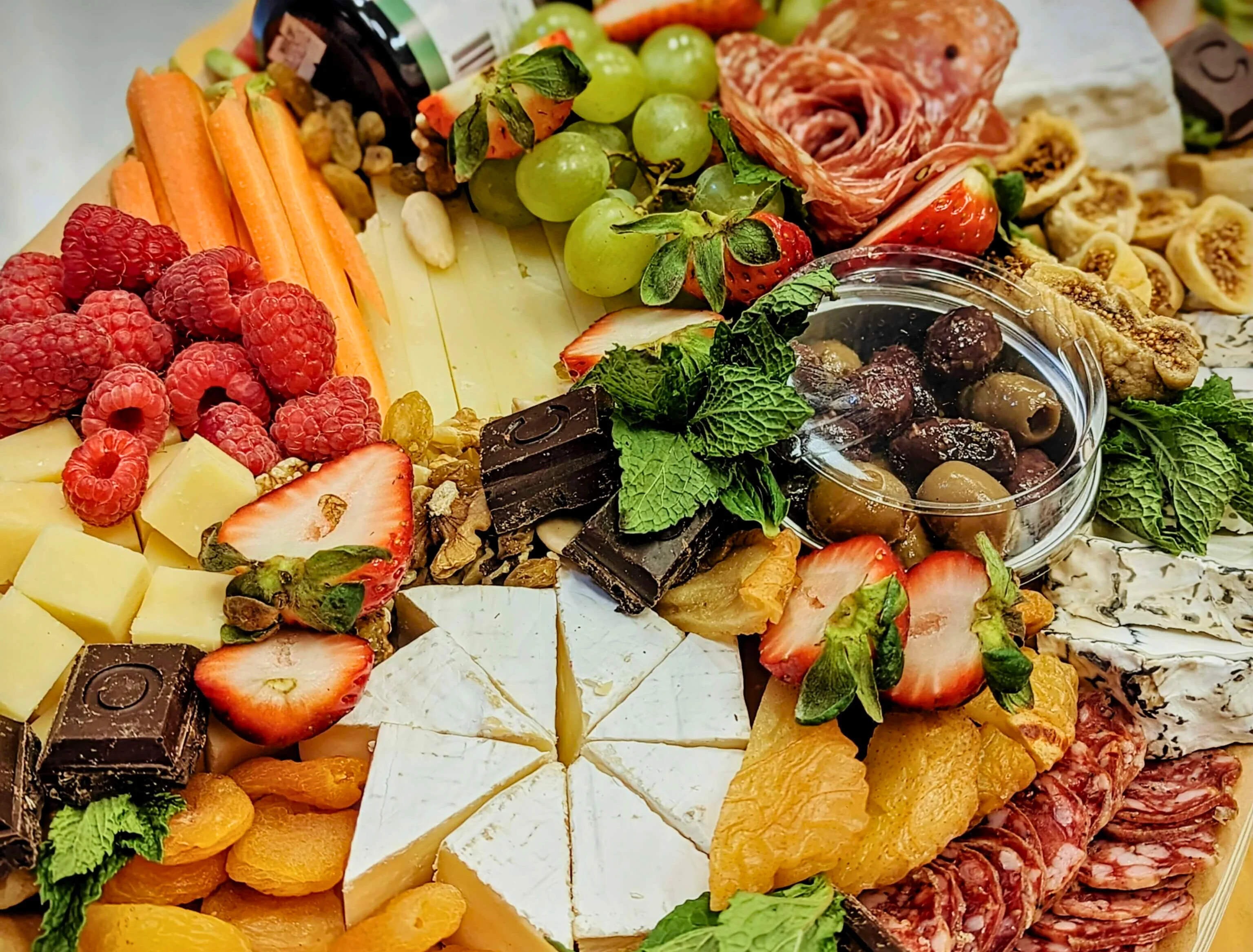 Artisan cheese and charcuterie board with fresh fruits