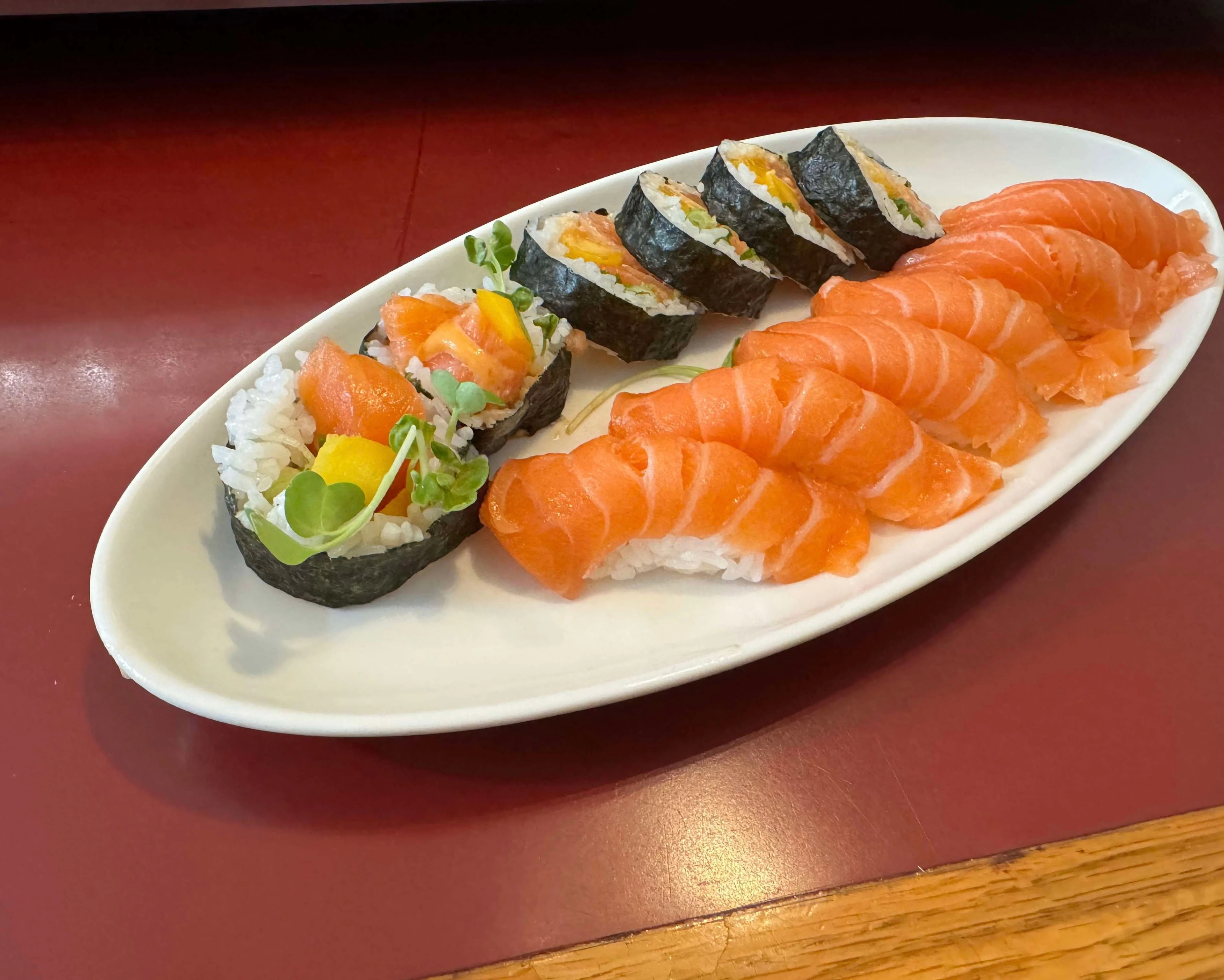 Japanese sushi platter featuring salmon nigiri and rolls