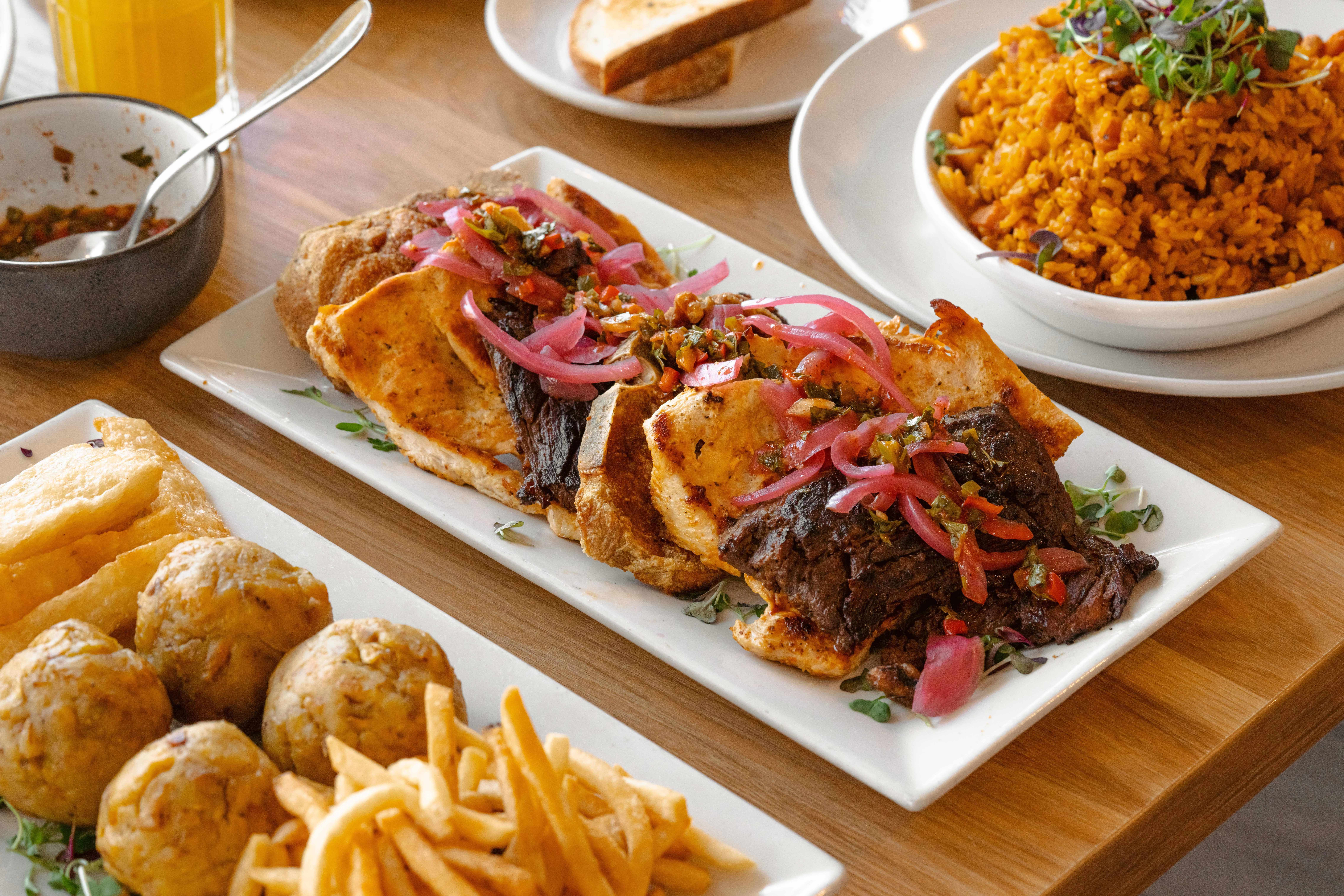 Nigerian jollof rice with grilled meats and plantains
