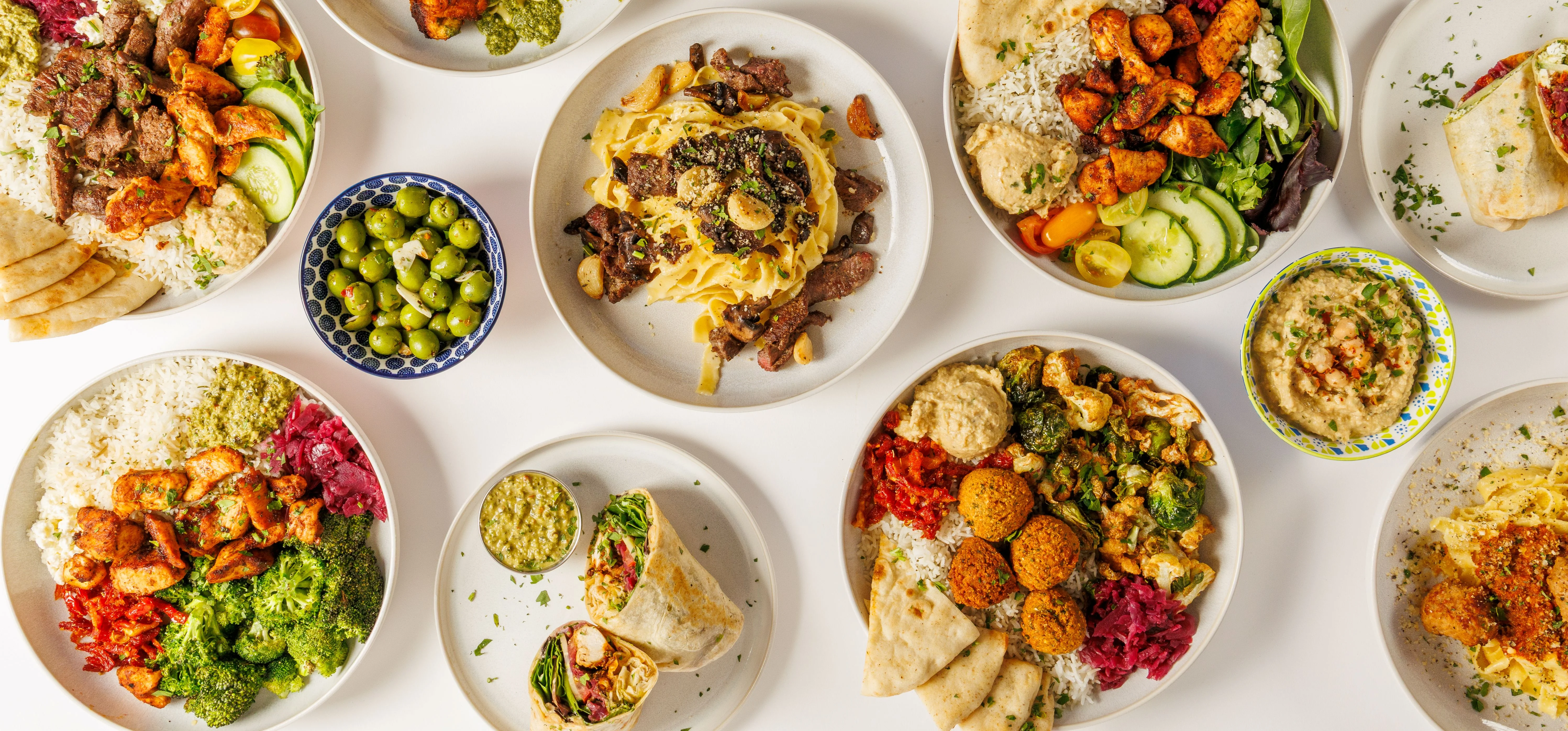 Variety of Mediterranean grain bowls and pasta dishes