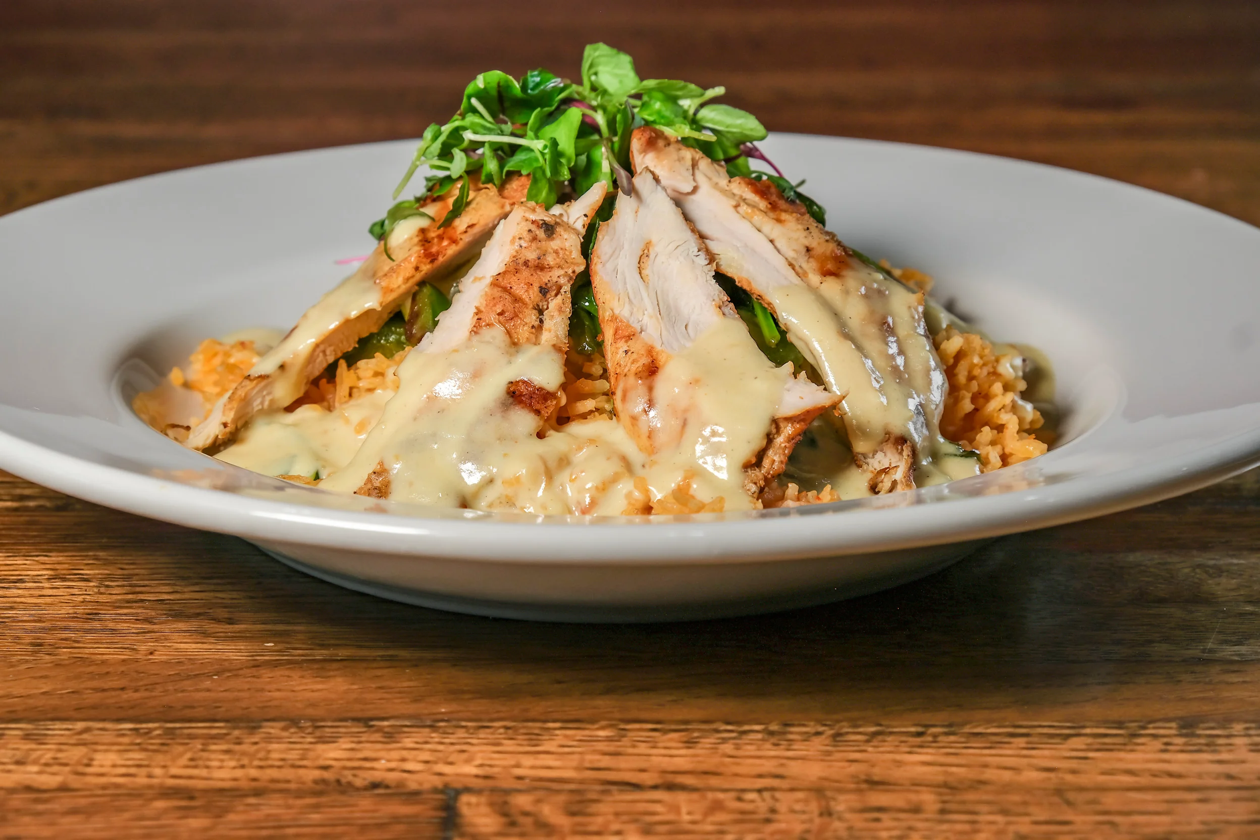 Grilled chicken over Mexican rice with creamy sauce