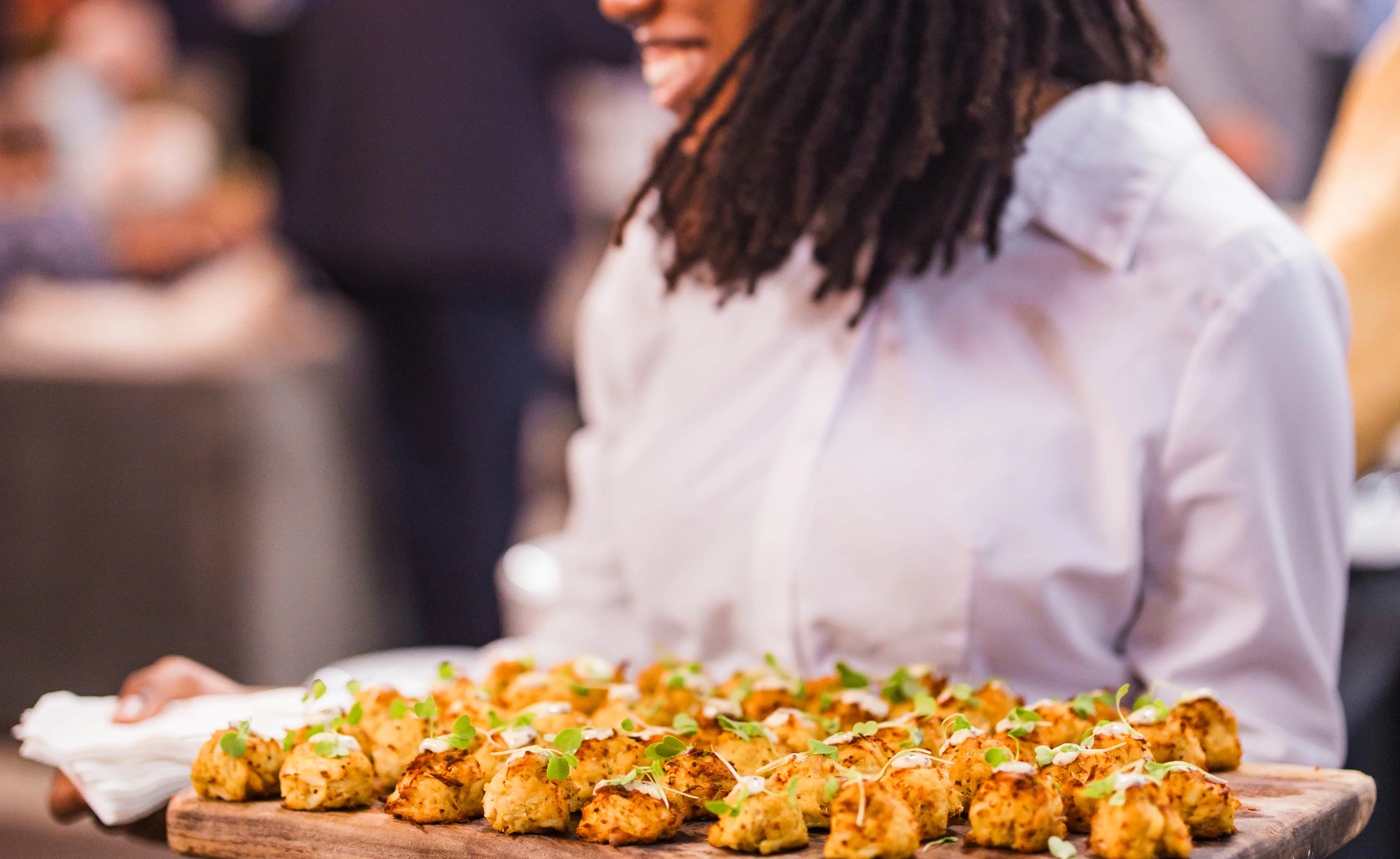 Catering platter of crab cakes with microgreens