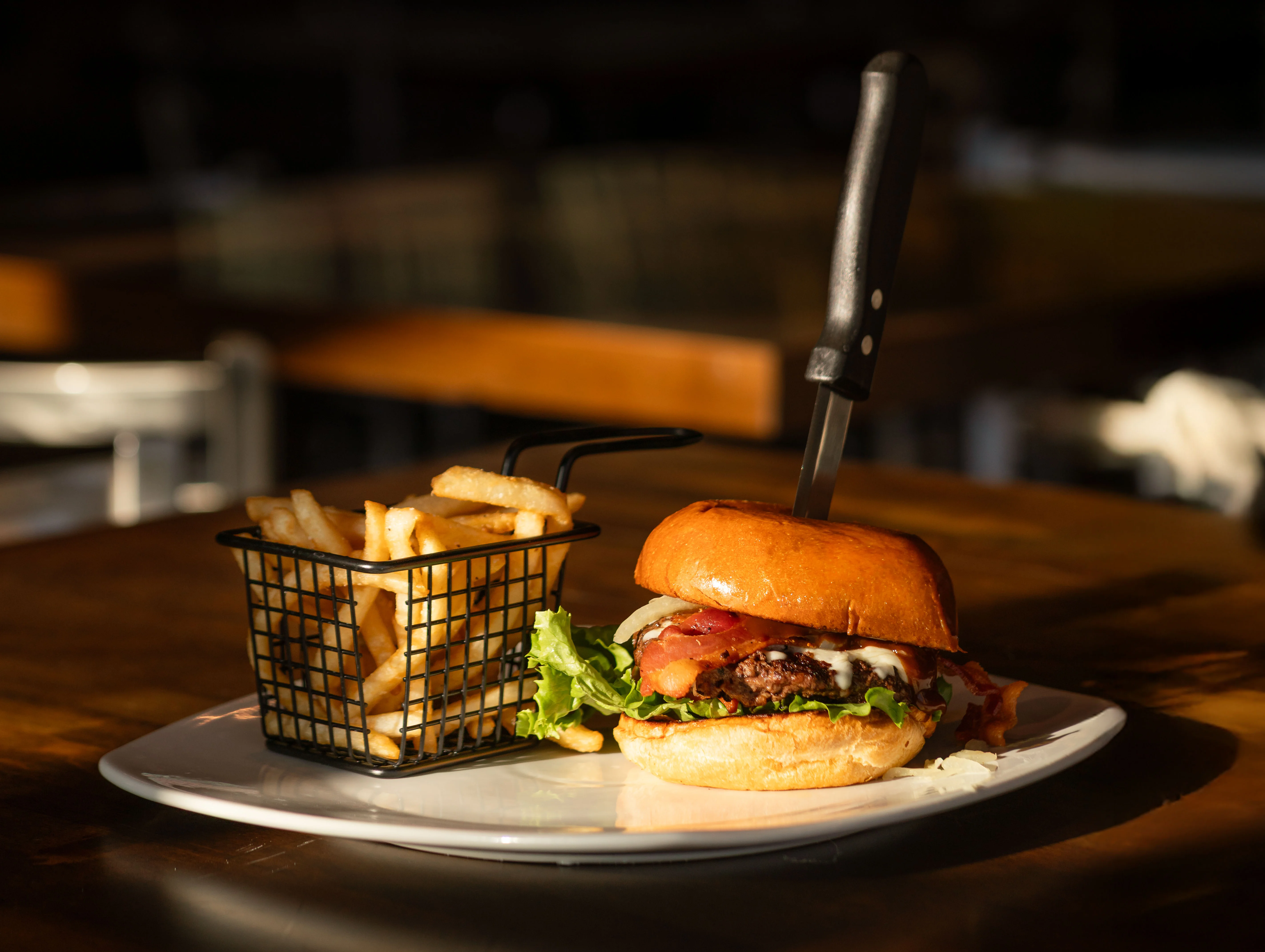 Delicious gourmet burger with fresh toppings on a wooden table