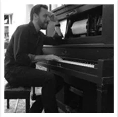 Musician playing piano in a cozy setting