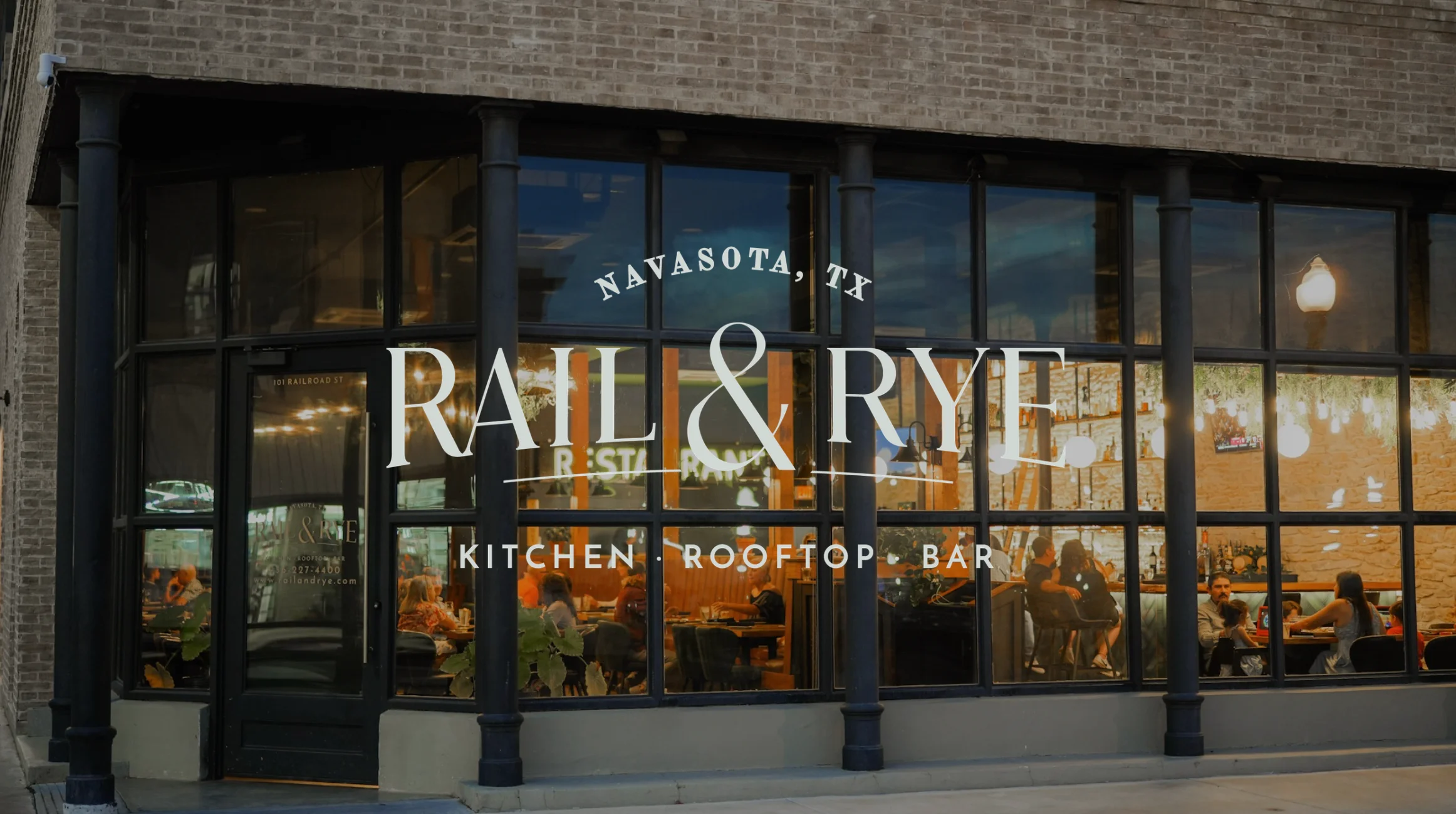 Modern restaurant exterior with rooftop bar in Navasota, TX