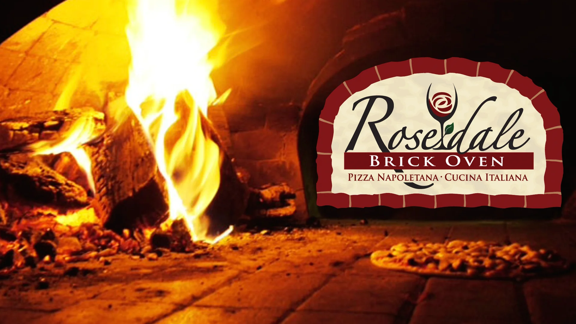 Pizza cooking in a wood burning brick oven