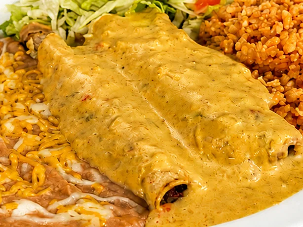 Plate of enchiladas with rice and beans, a classic Mexican dish