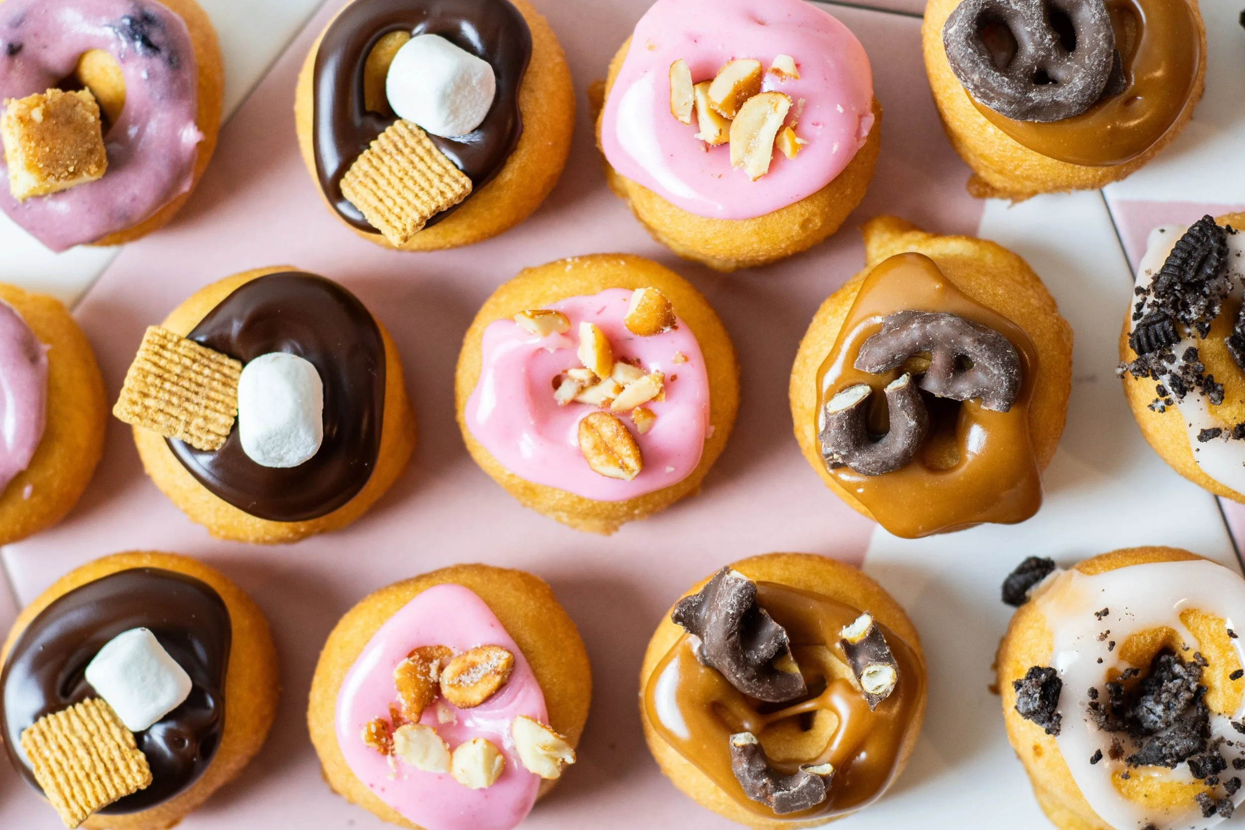Colorful mini donuts with various toppings and glazes