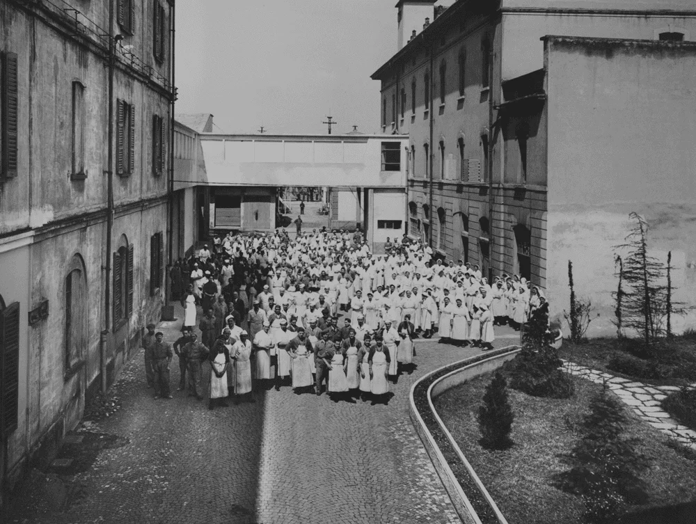Historical gathering of people in a courtyard