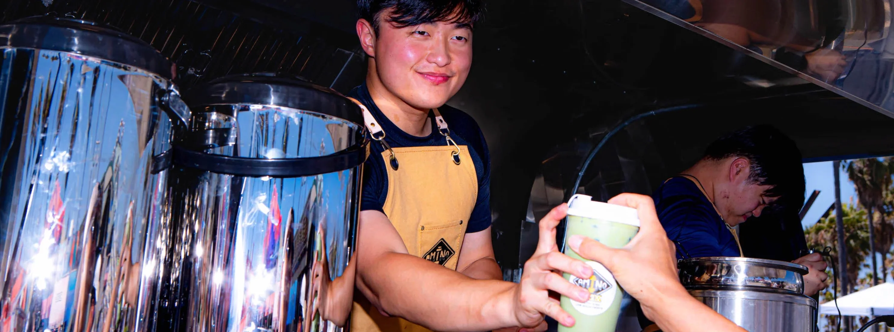 Barista serving refreshing green tea drink at a food festival