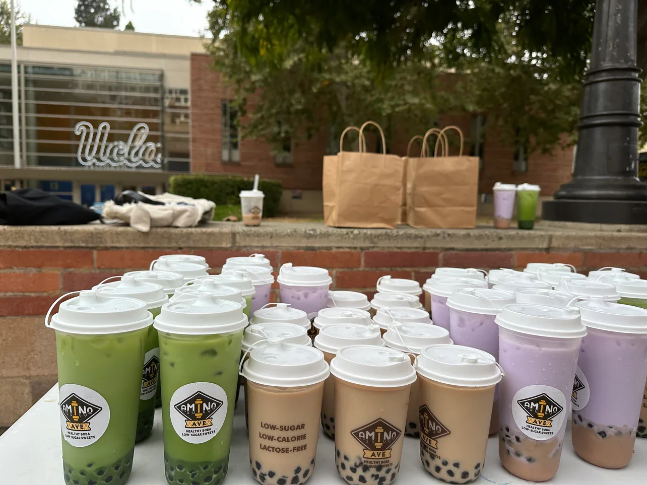 Colorful bubble tea drinks displayed outdoors at UCLA
