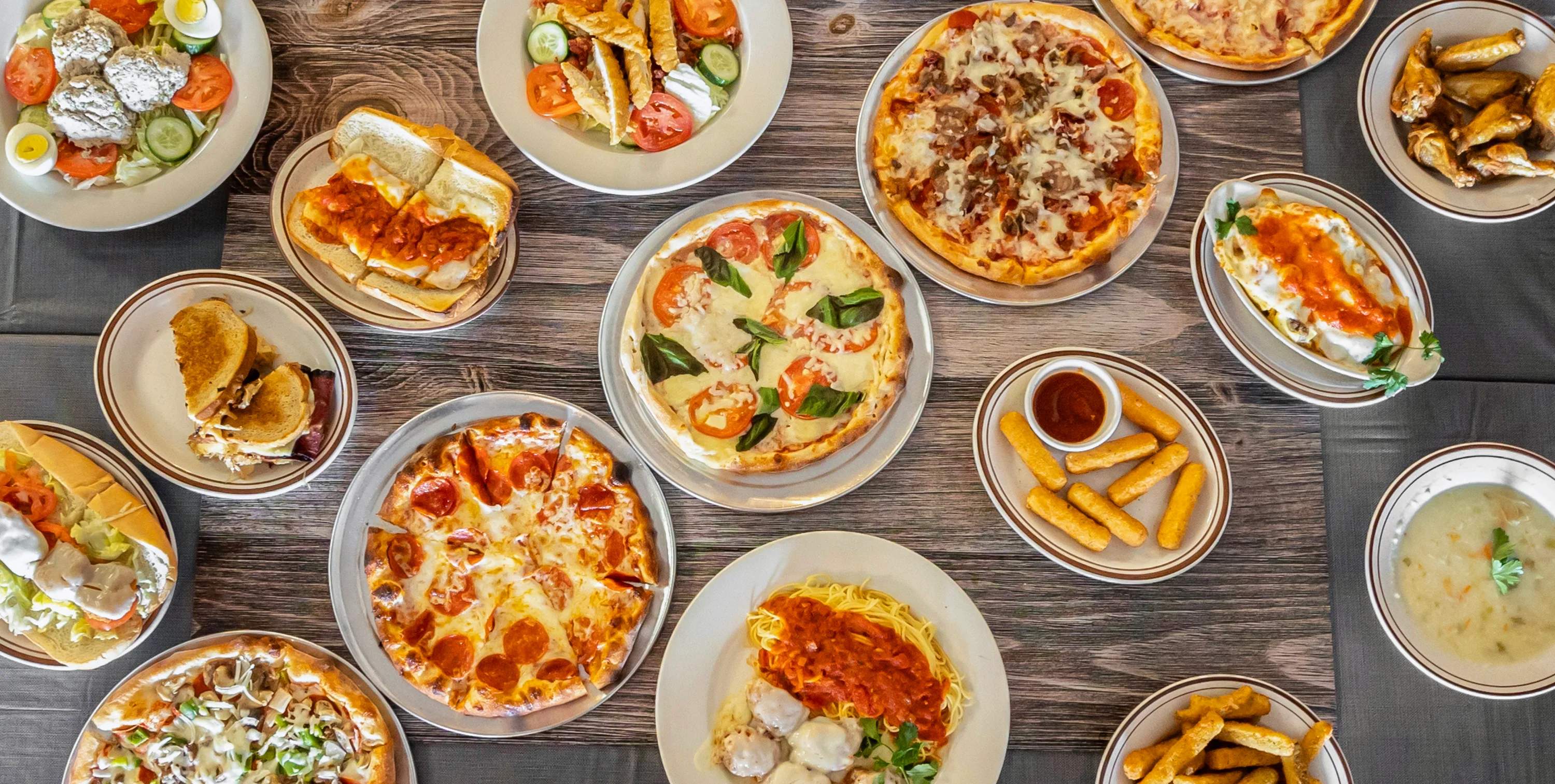 Assorted Mediterranean dishes including pizza and gyros
