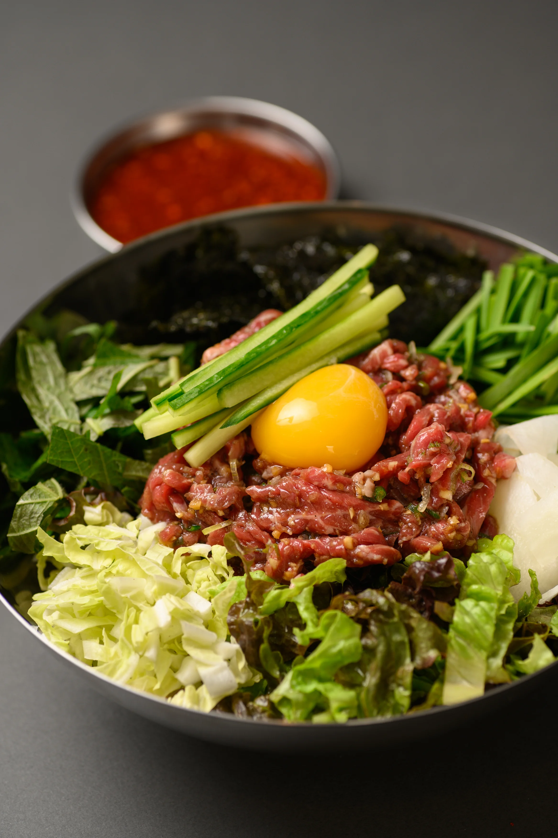 Korean yukhoe with fresh vegetables and egg yolk