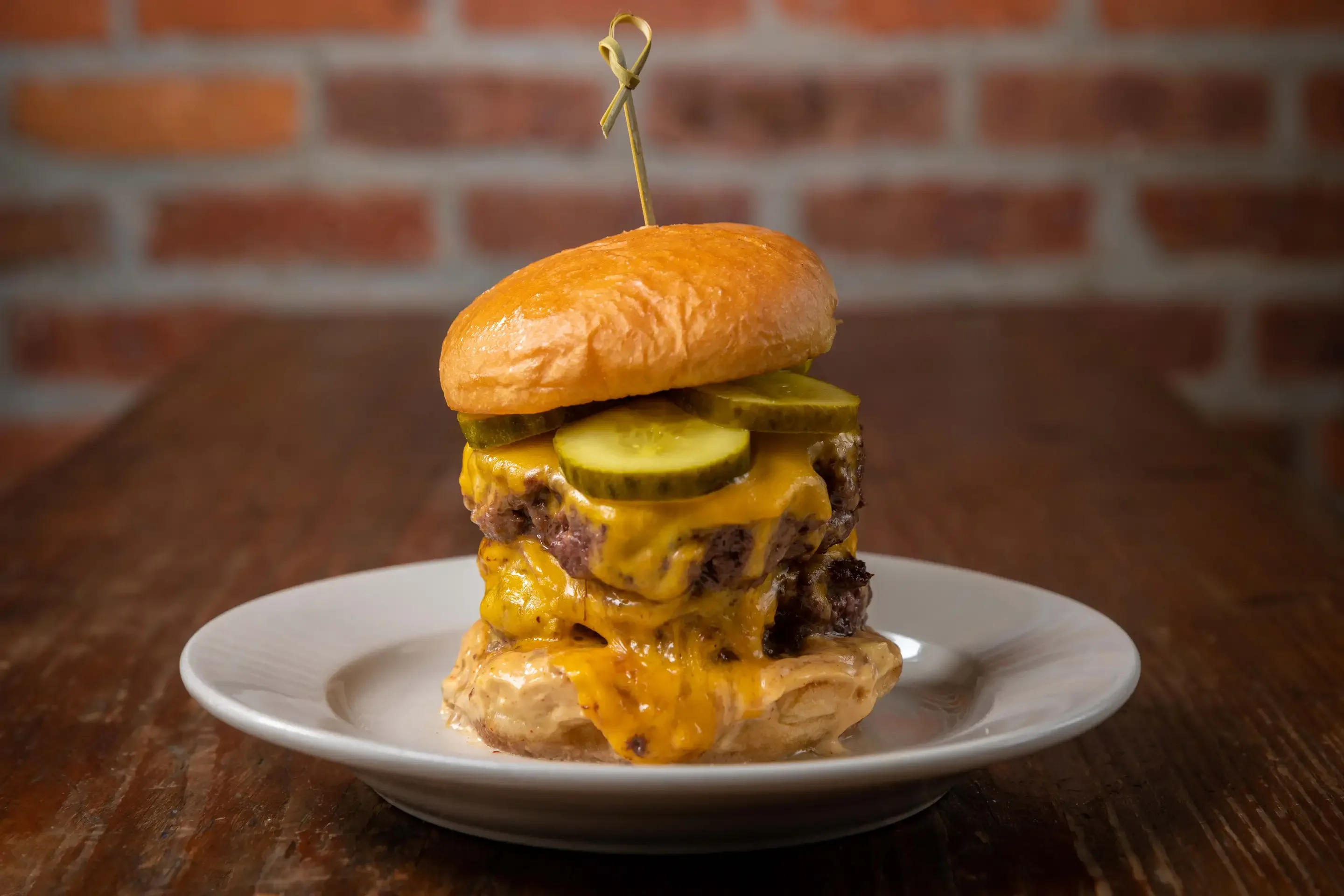 Juicy cheeseburger with pickles on a brioche bun