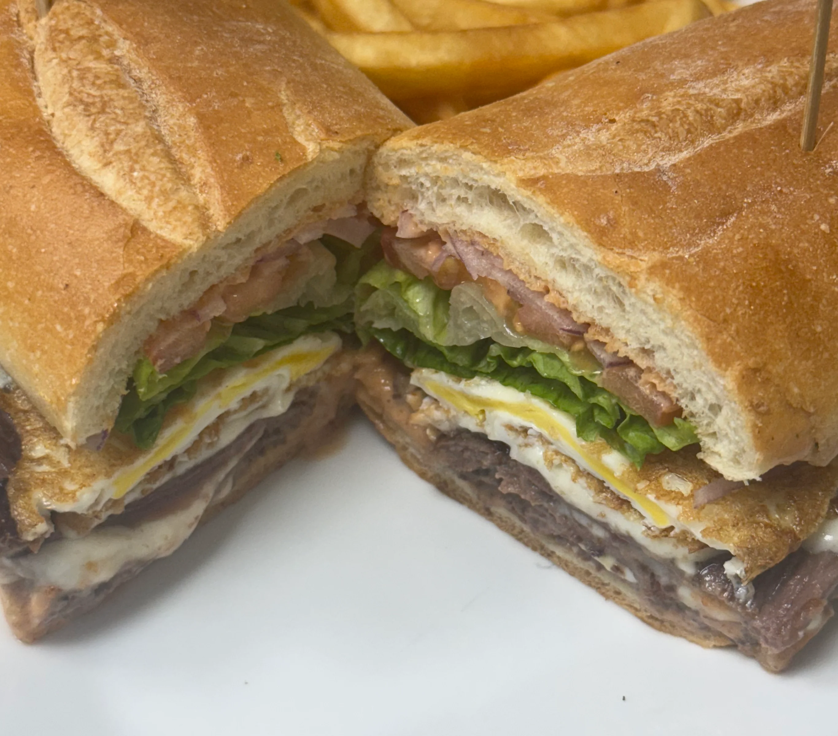 Hearty Cuban sandwich with layers of meat and fresh vegetables
