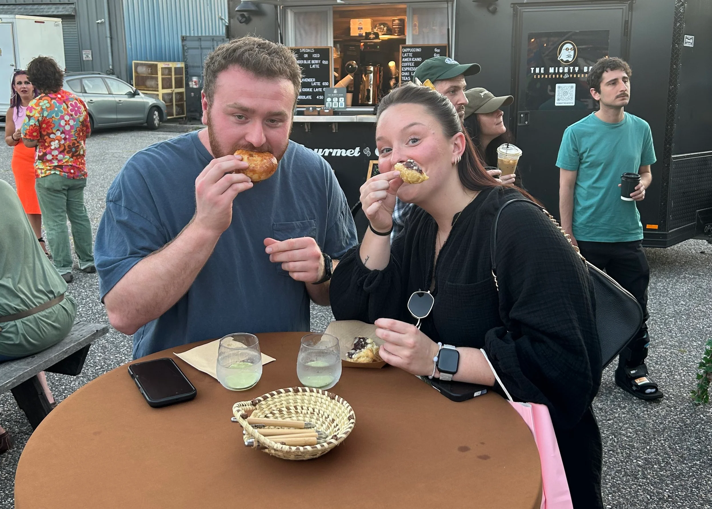 Couple enjoying gourmet street food at a food truck event