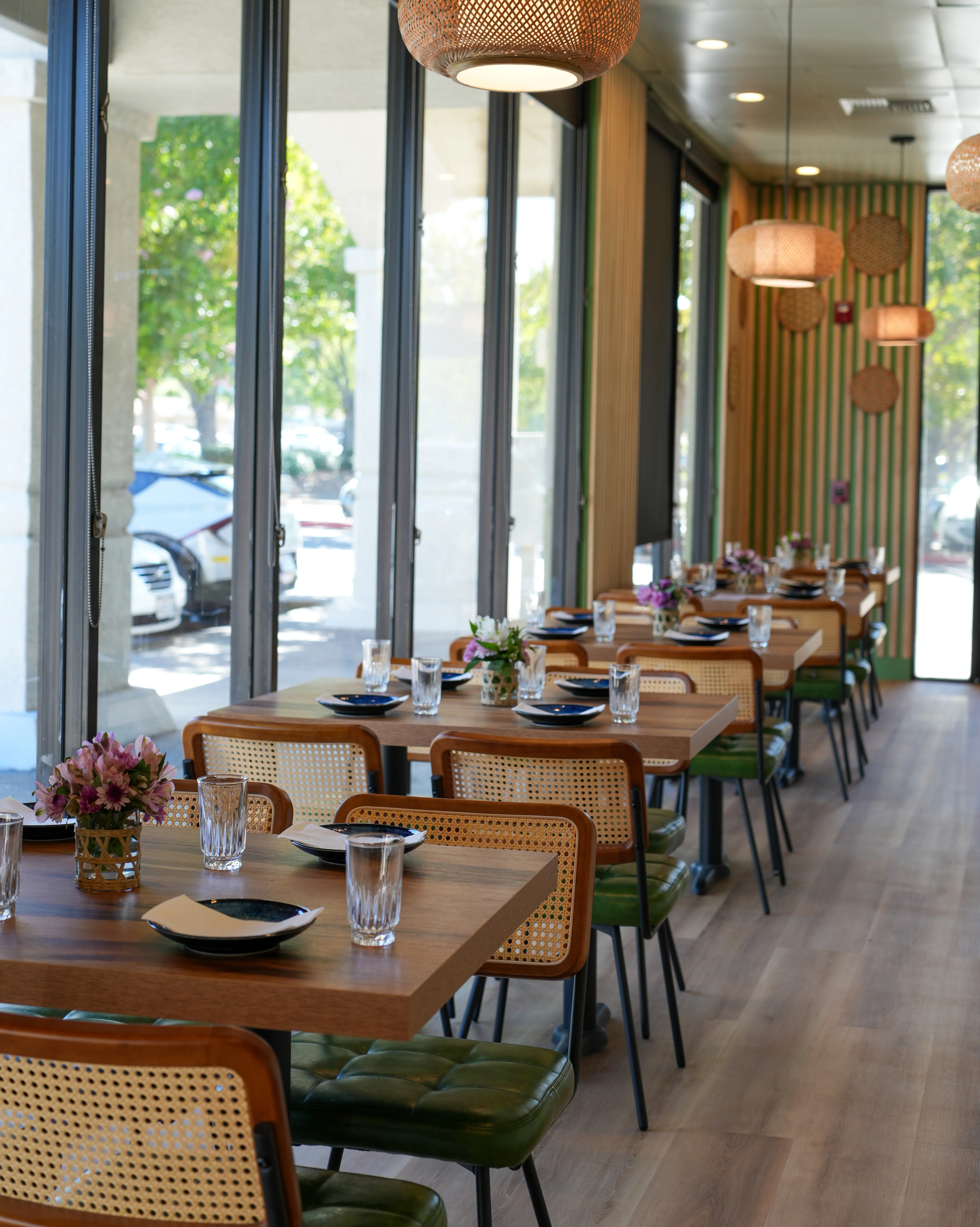 Modern restaurant interior with wooden tables and pendant lighting