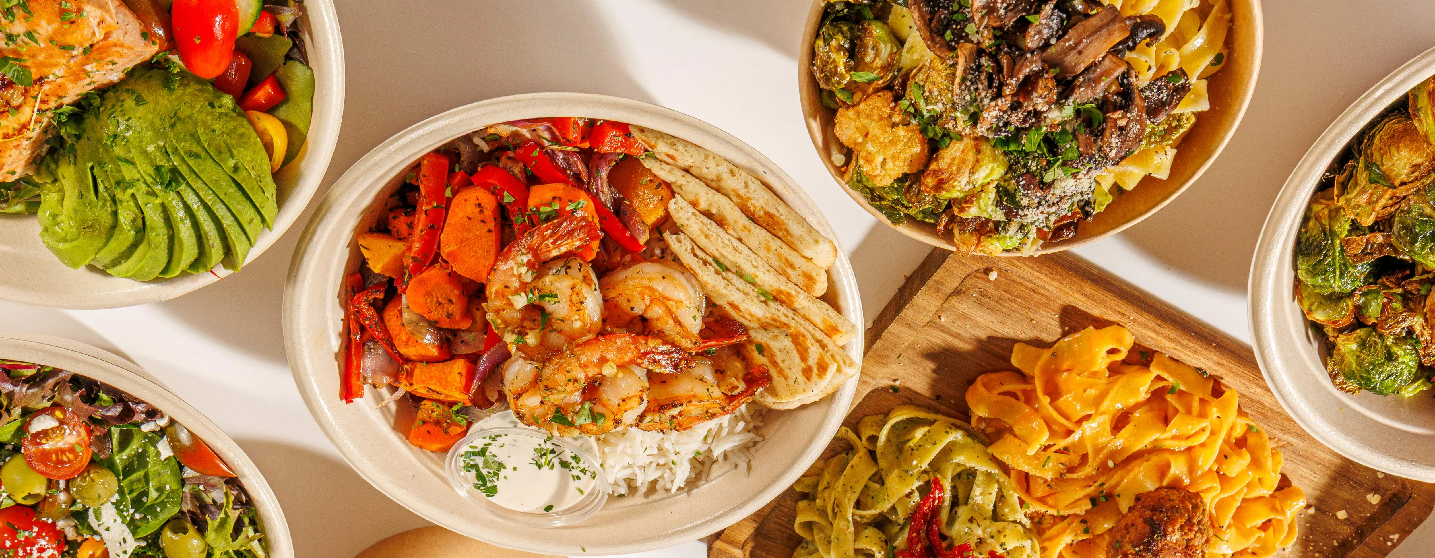 Variety of Mediterranean grain bowls and pasta dishes
