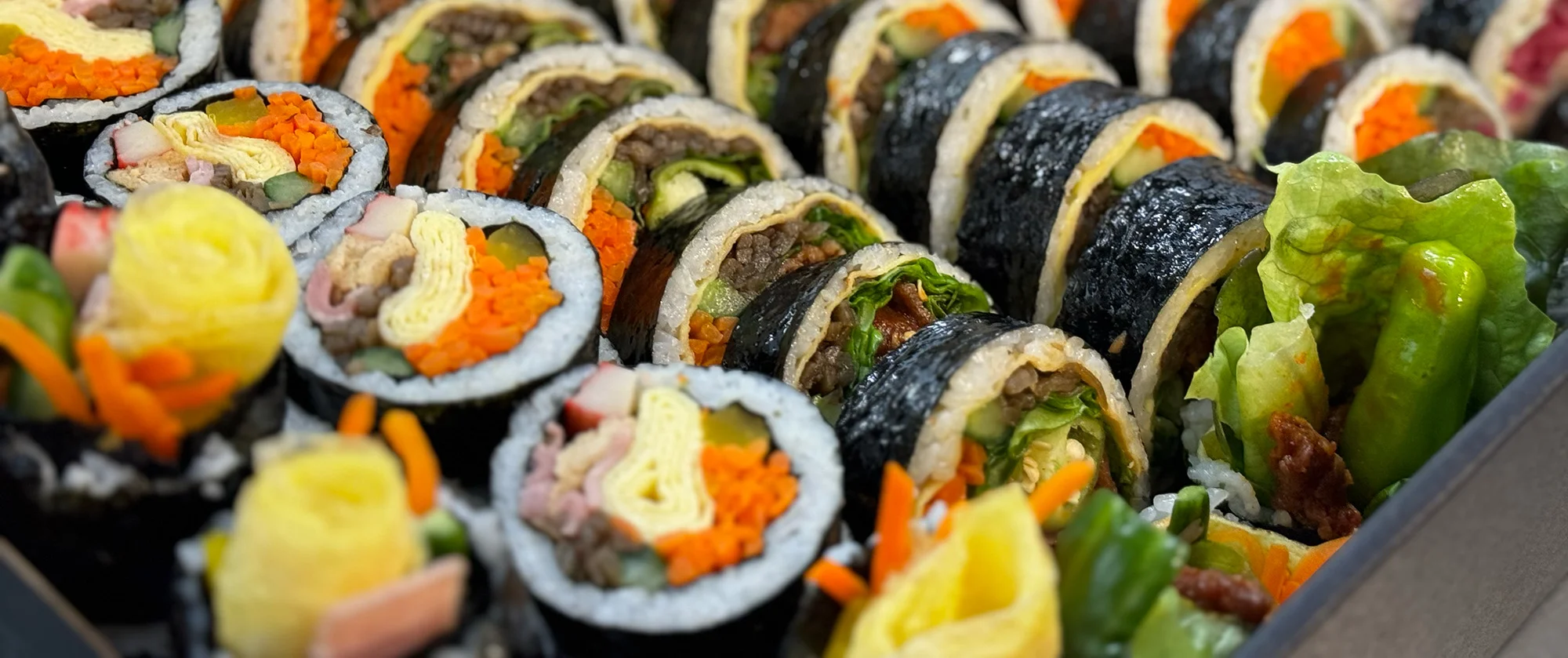 Assorted Korean gimbap rolls beautifully arranged