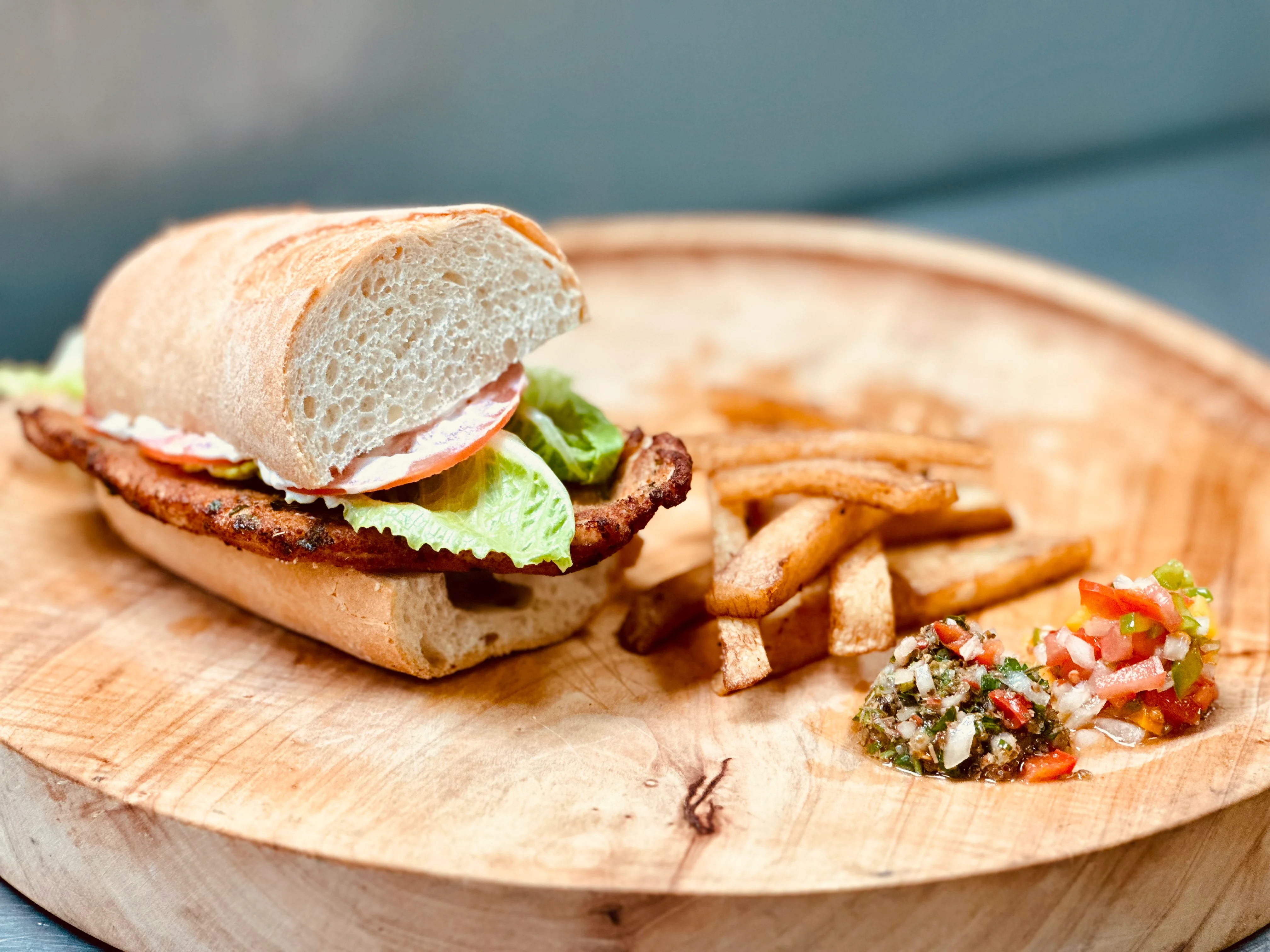 Crispy chicken sandwich with fries and salsa
