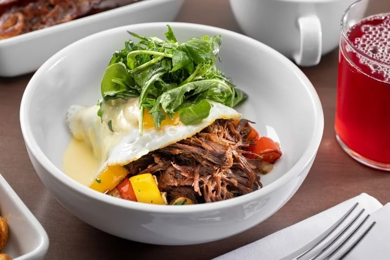 Savory Mexican barbacoa bowl with fried egg and greens