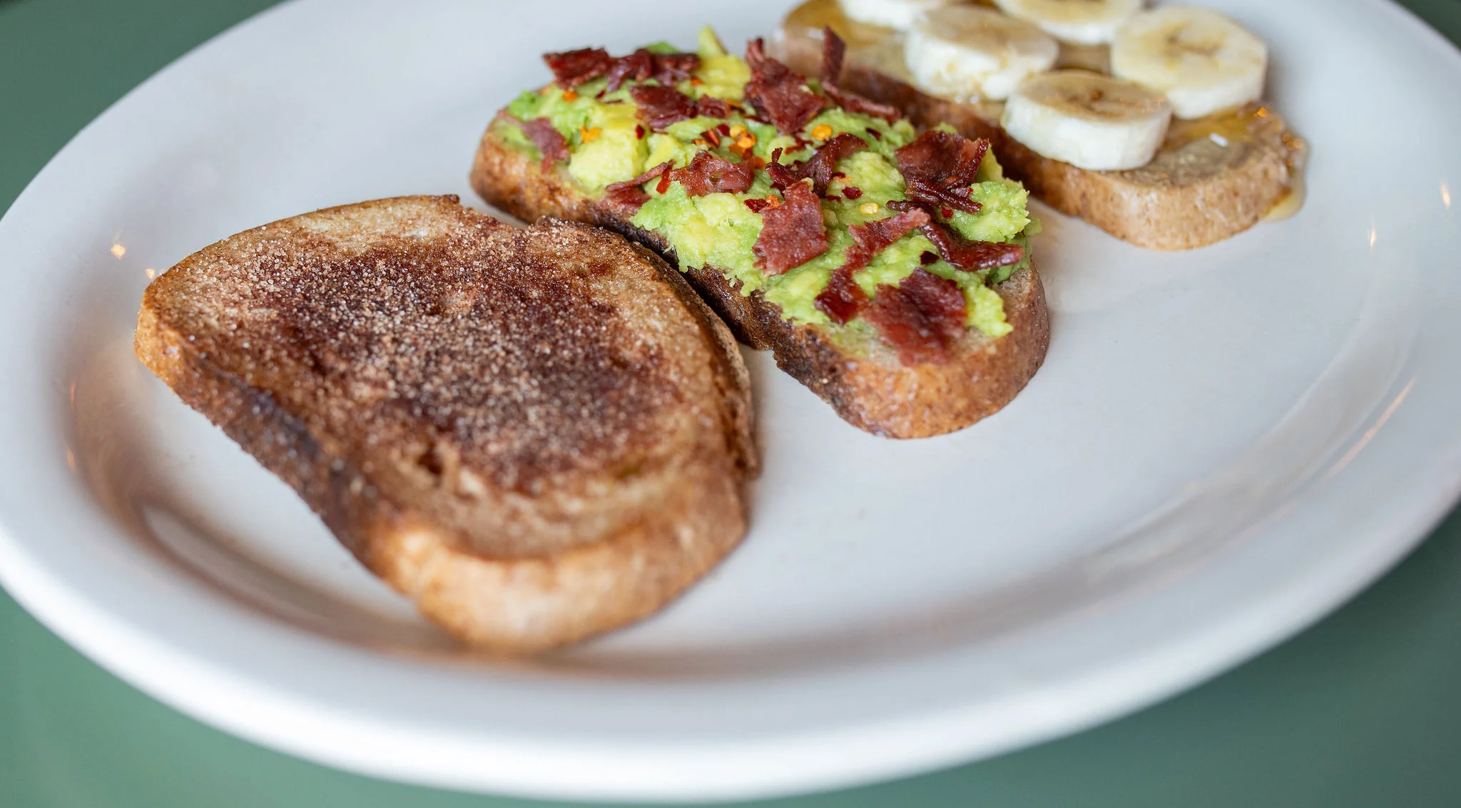 Avocado toast with bacon and banana on whole grain bread