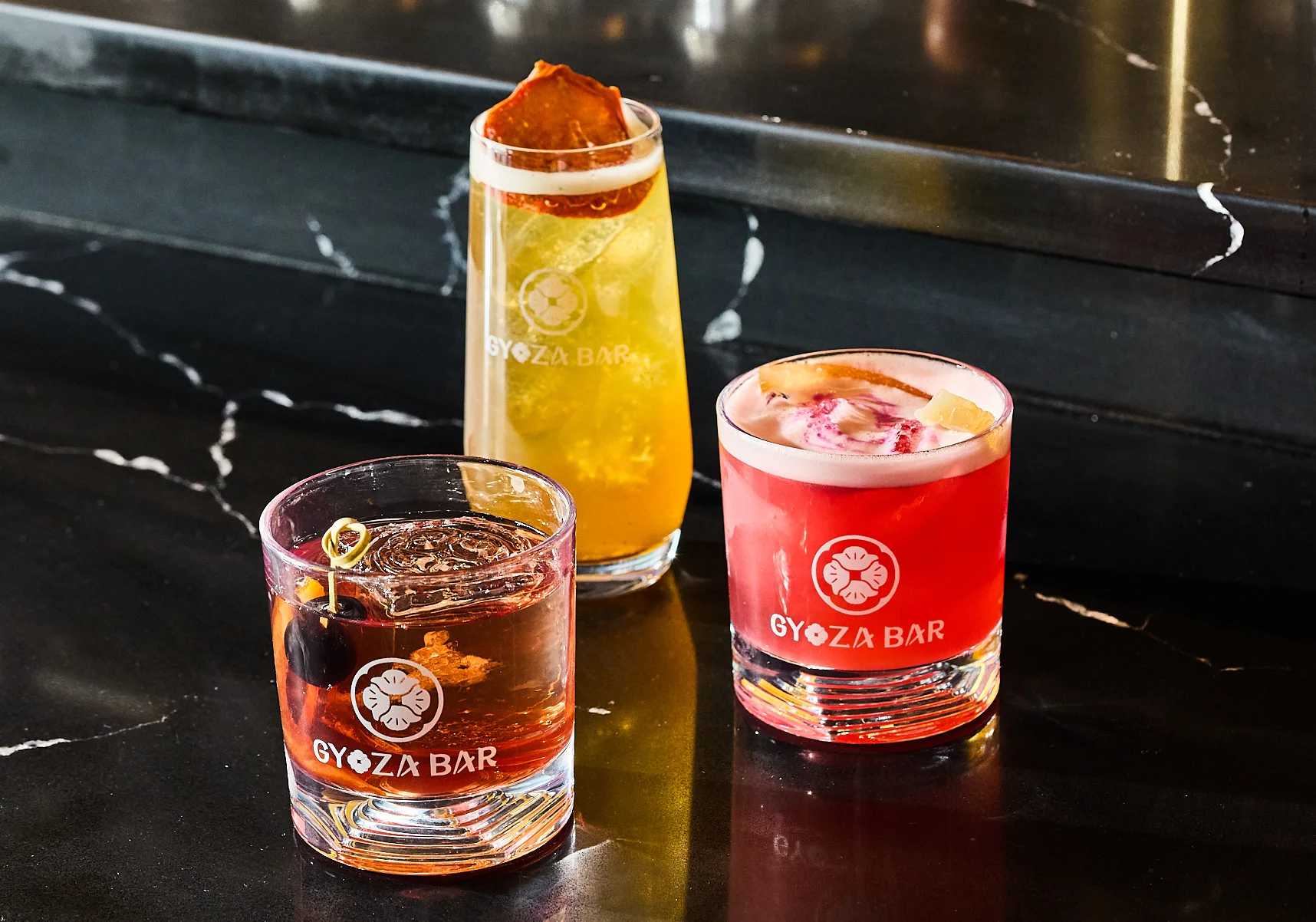 Colorful cocktails at Gyoza Bar on a sleek black countertop