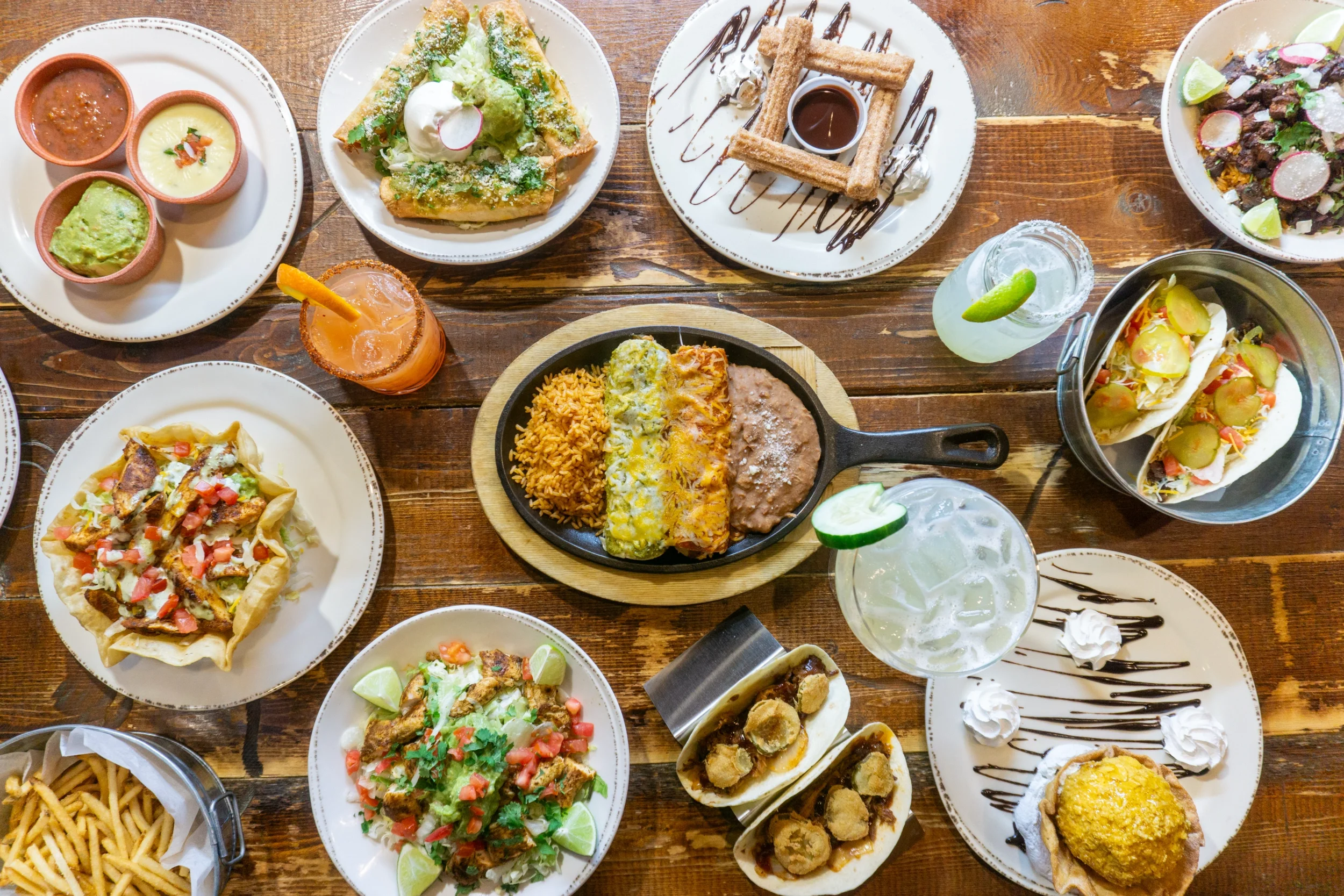 Colorful Mexican feast with enchiladas, tacos, and churros