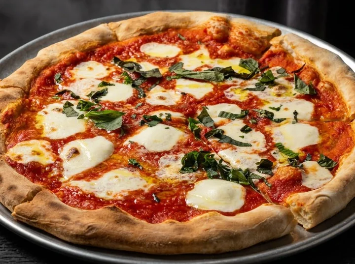 A classic Margherita pizza featuring fresh mozzarella cheese, basil, and a rich tomato sauce on a crispy crust.