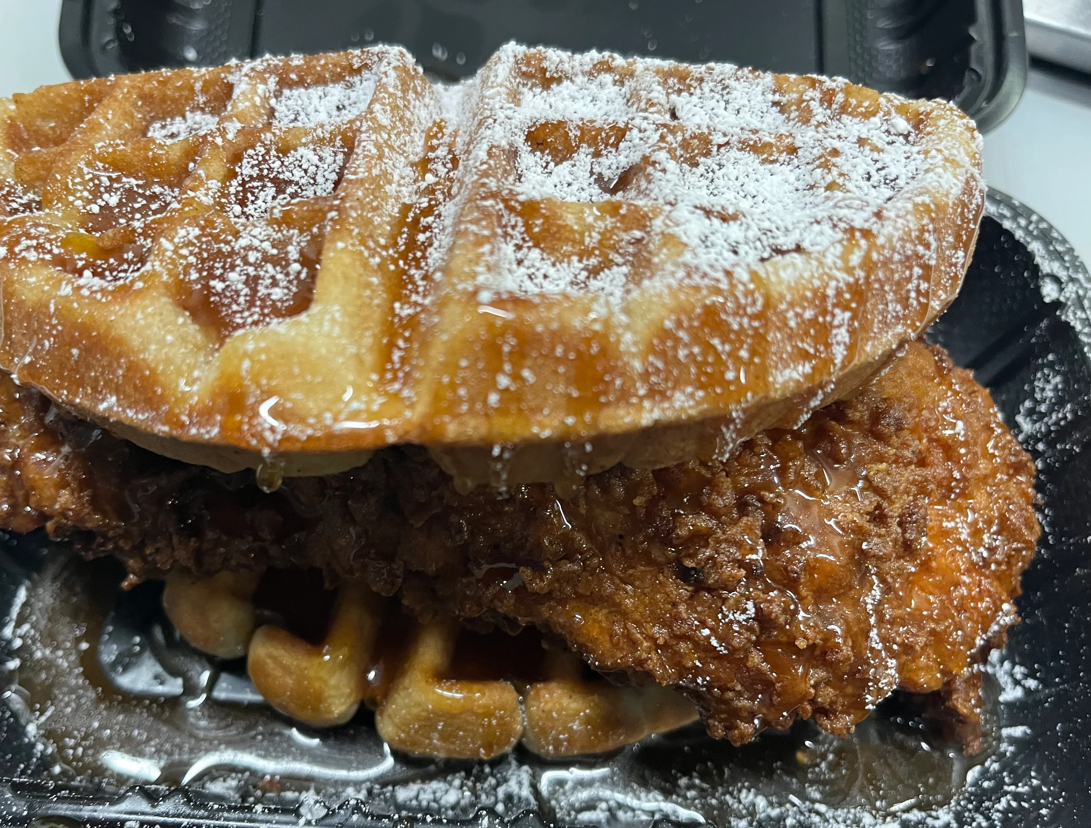 Southern chicken and waffles drizzled with syrup