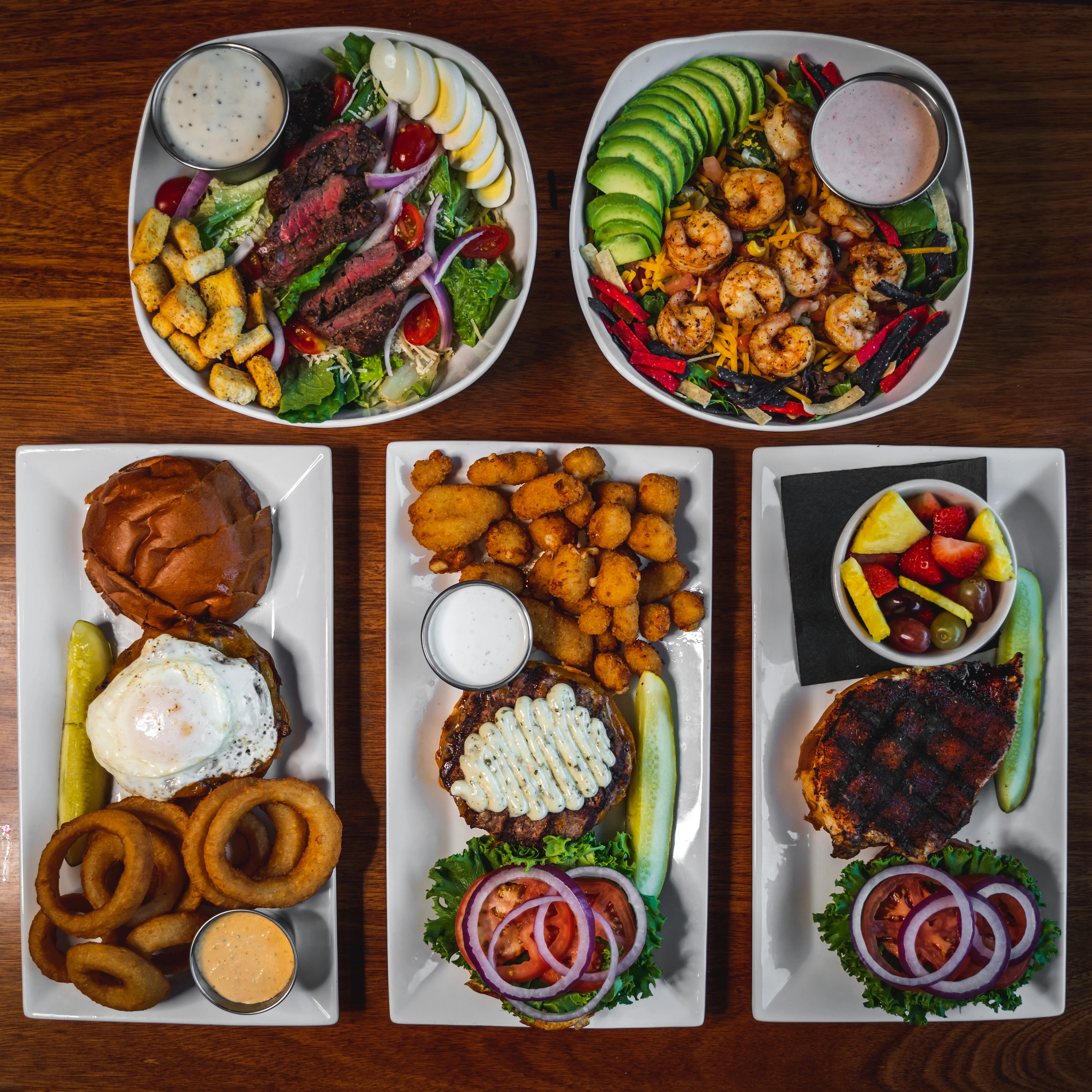 Delicious gourmet burger with fresh toppings on a wooden table