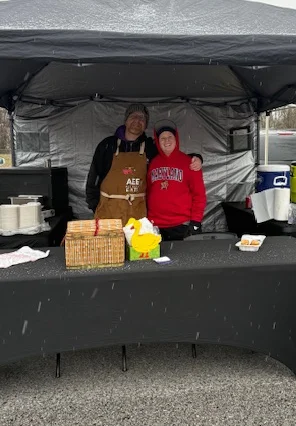 Food stall at a market featuring crab cakes and fresh eats
