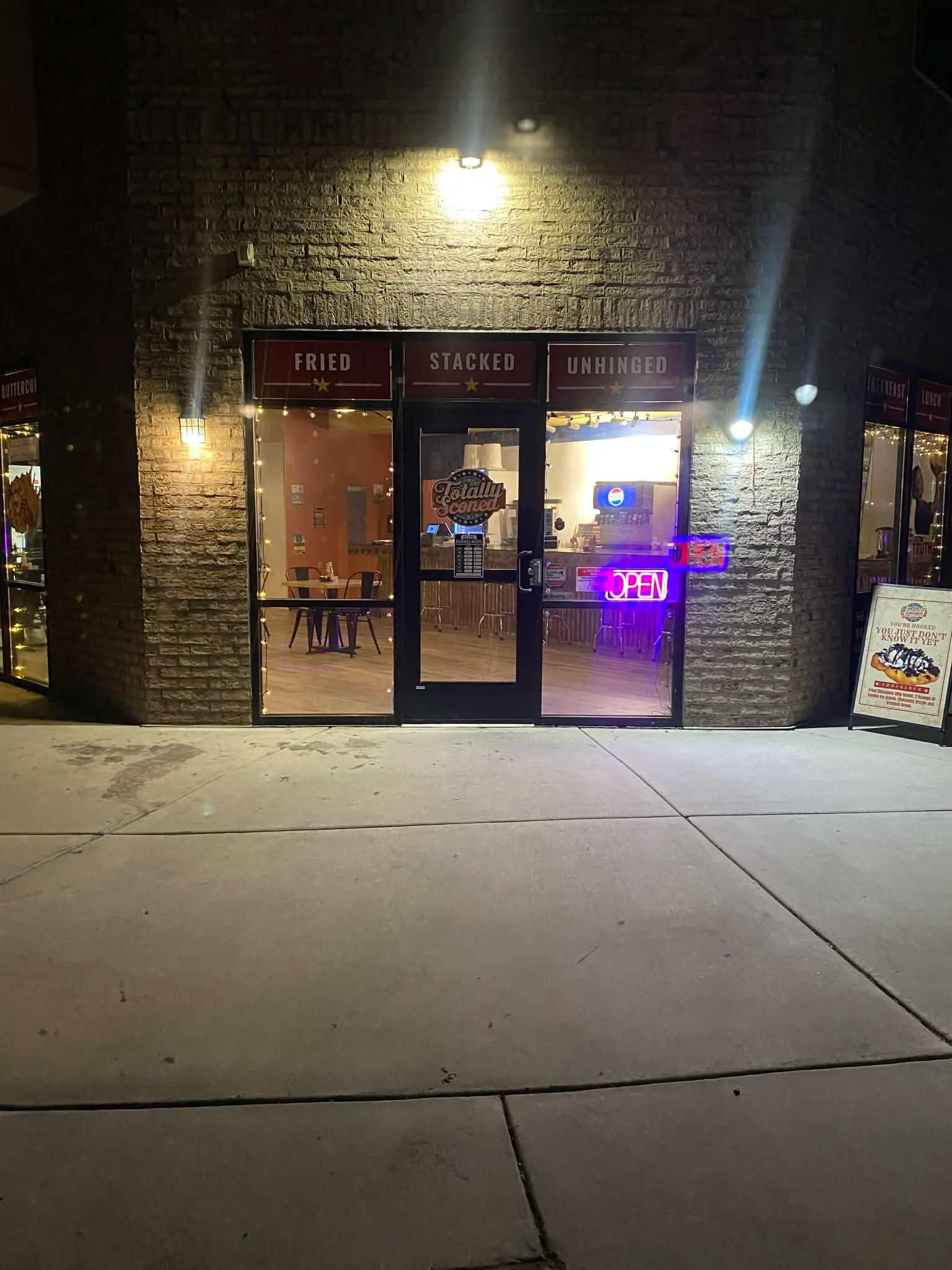 Cozy restaurant entrance with neon 'OPEN' sign