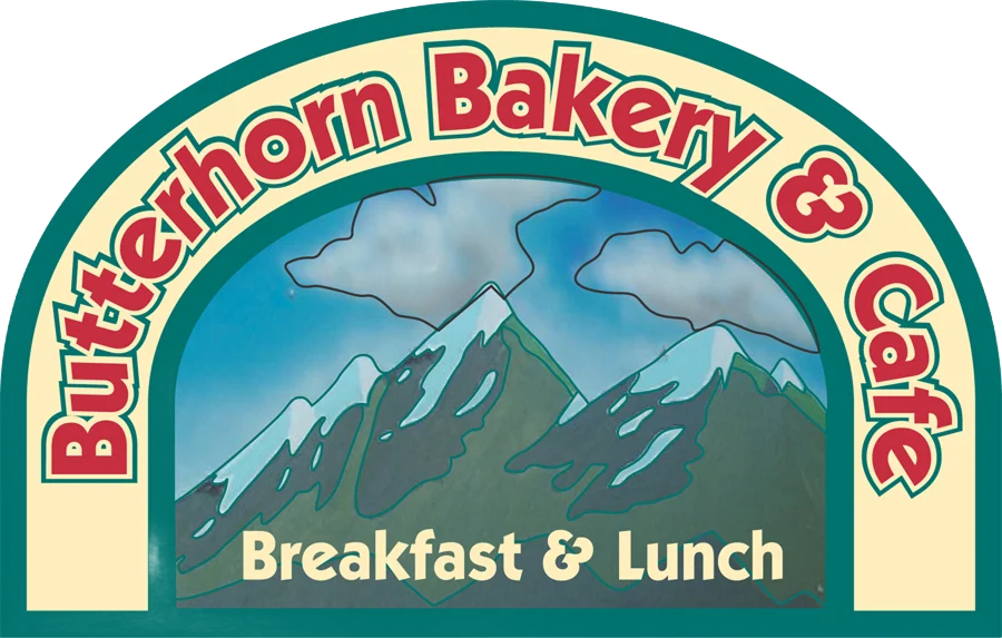 Colorful logo of Butterhorn Bakery & Cafe featuring mountains and breakfast theme