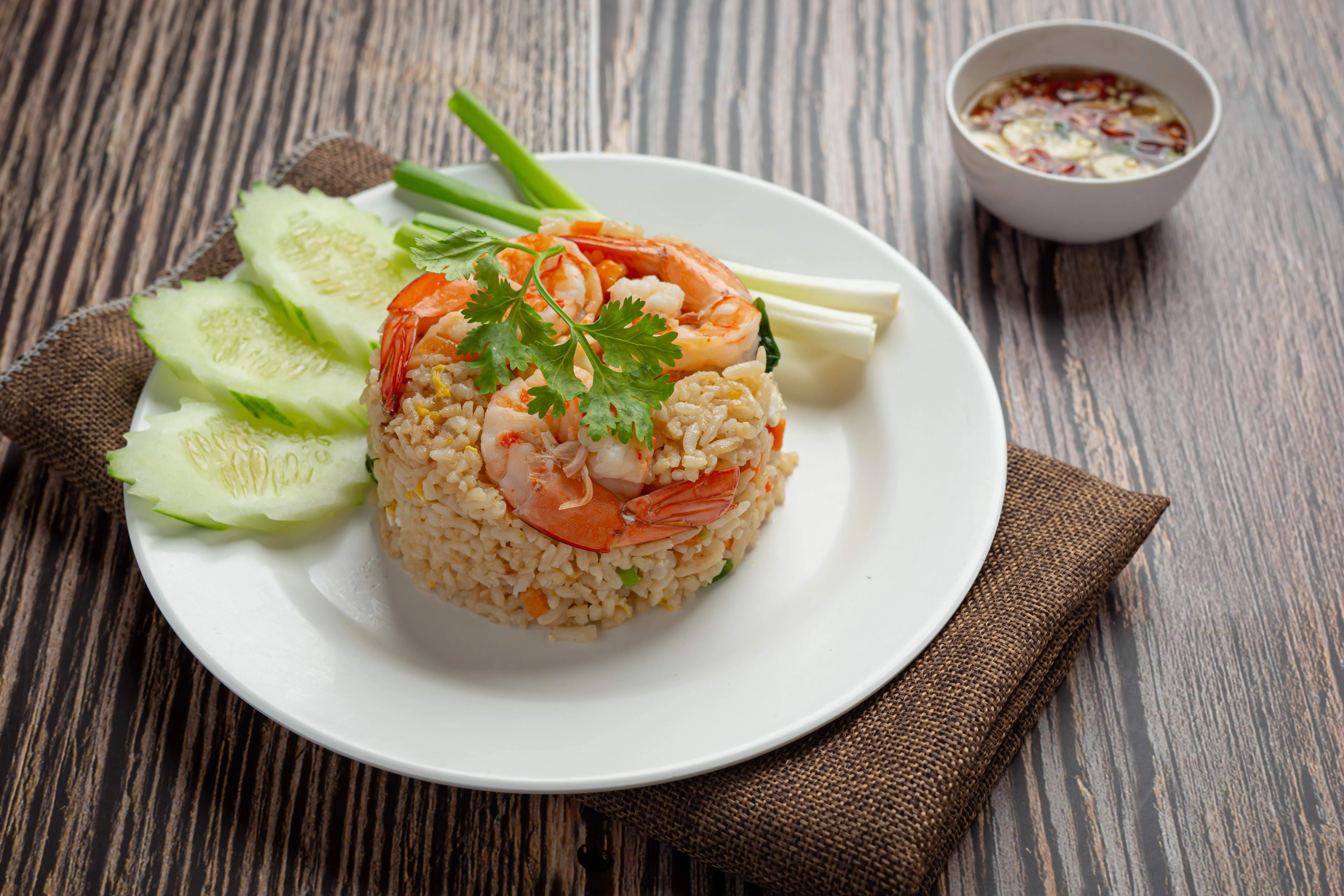 Shrimp fried rice served with cucumber and dipping sauce