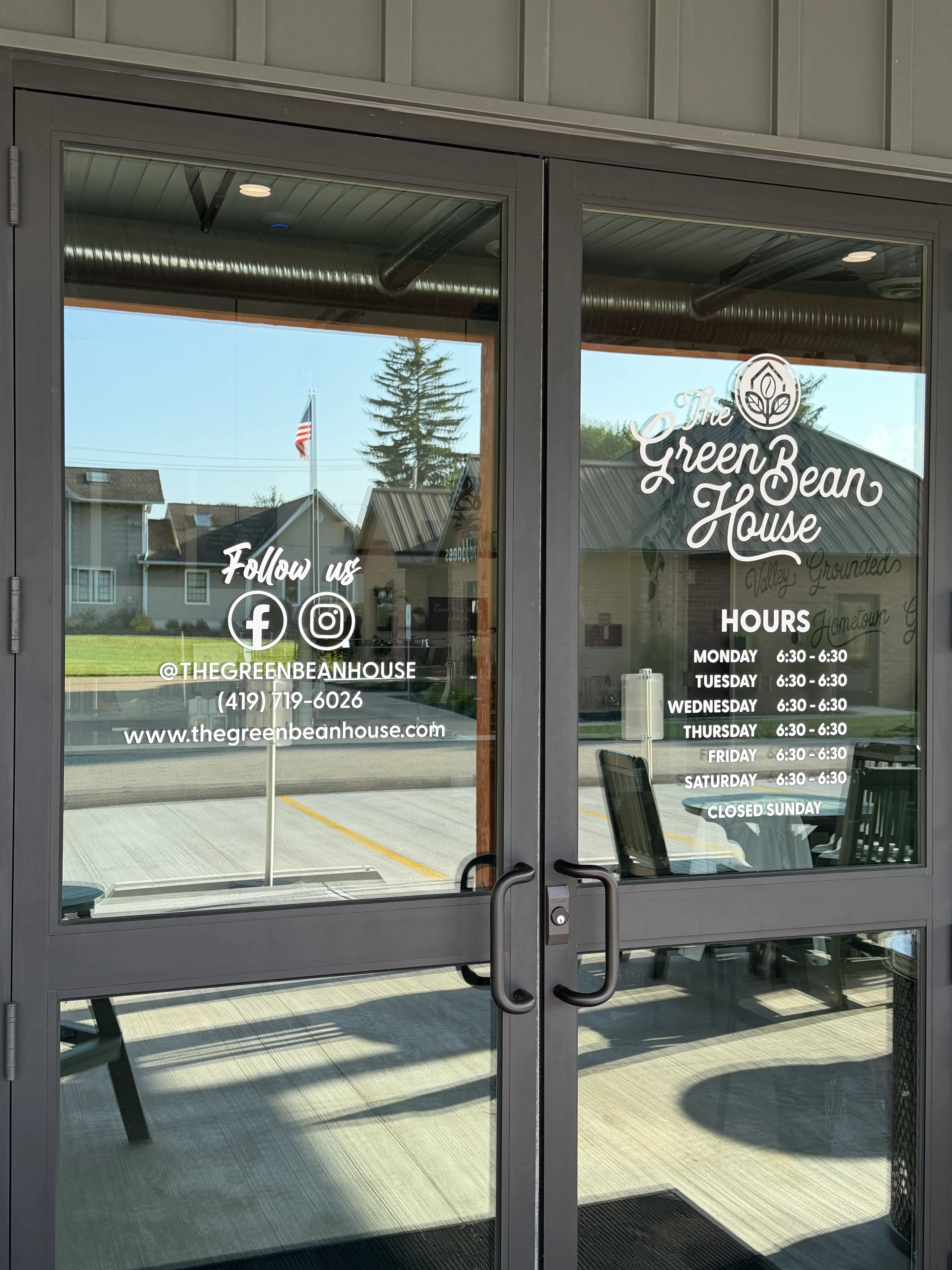 Entrance of The Green Bean House with hours and social media details