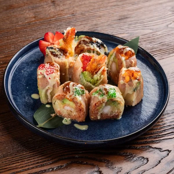 Colorful sushi rolls beautifully arranged on a blue plate