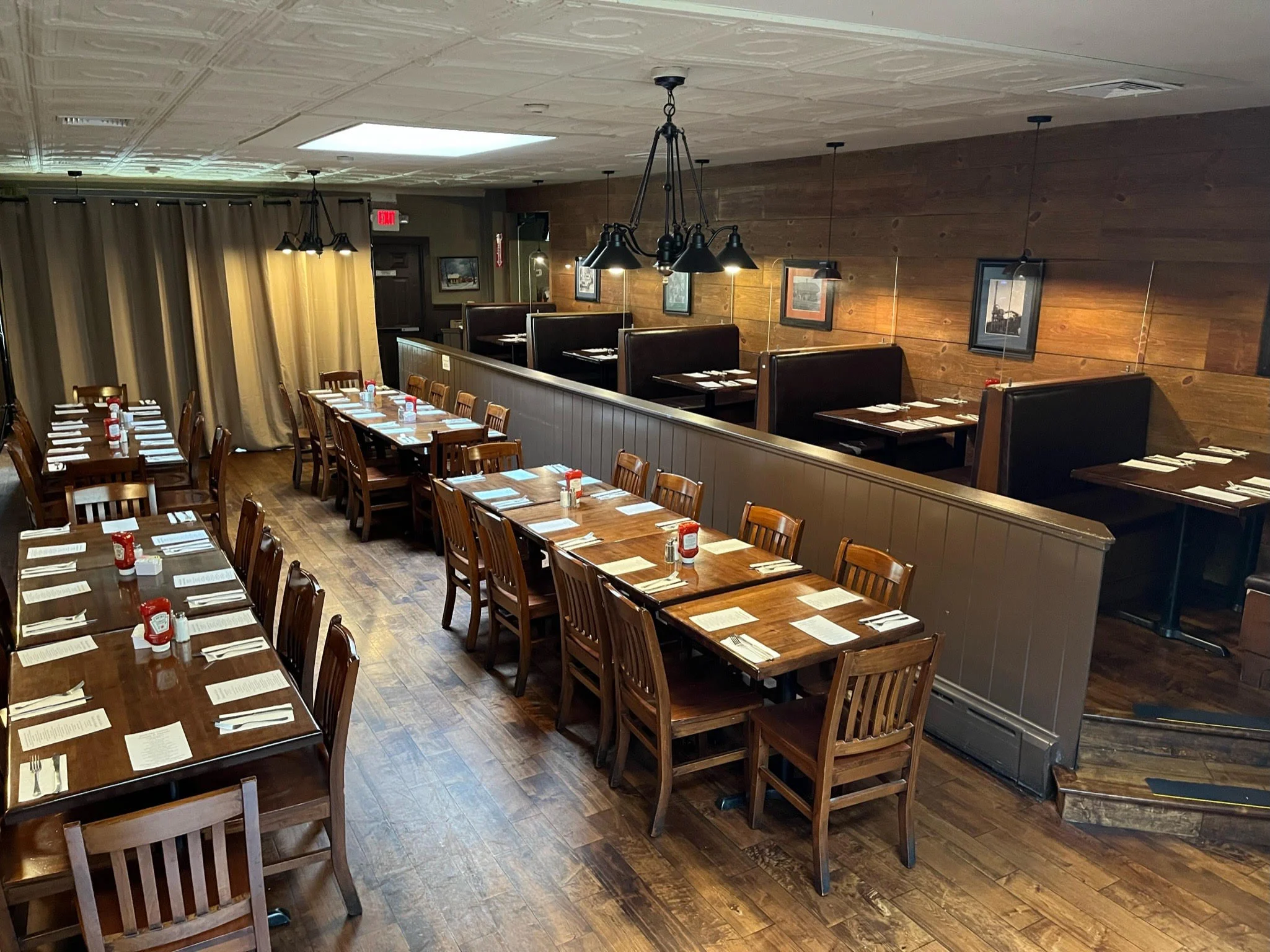 Cozy restaurant interior with wooden tables and booths
