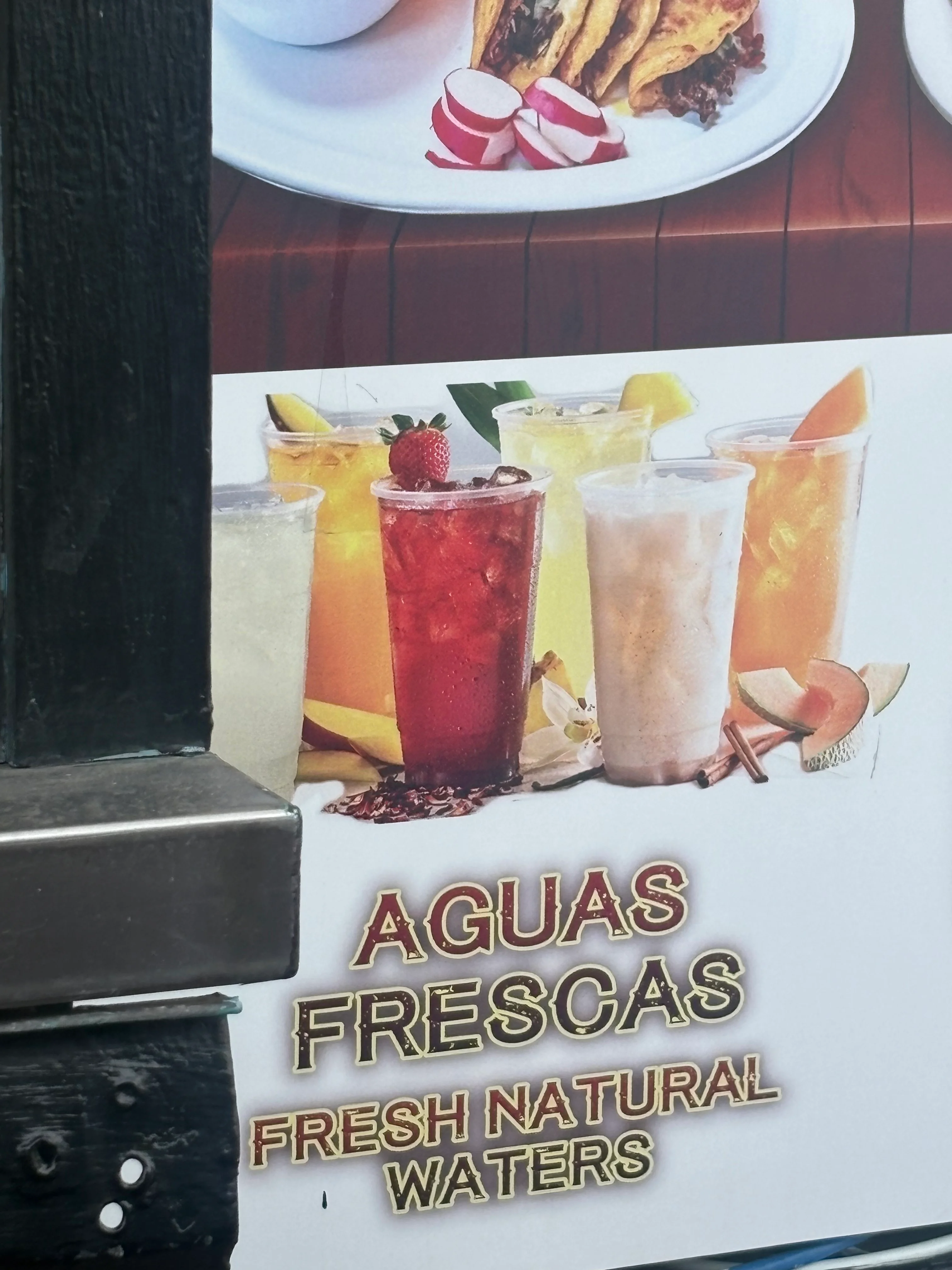 Colorful aguas frescas in clear cups on a restaurant menu