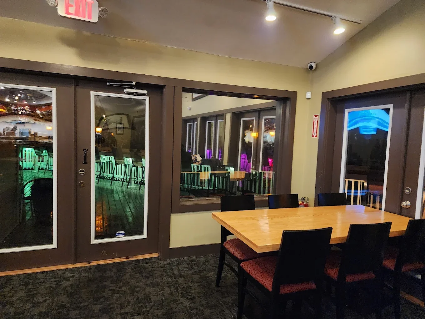 Cozy restaurant interior with large wooden table and outdoor view