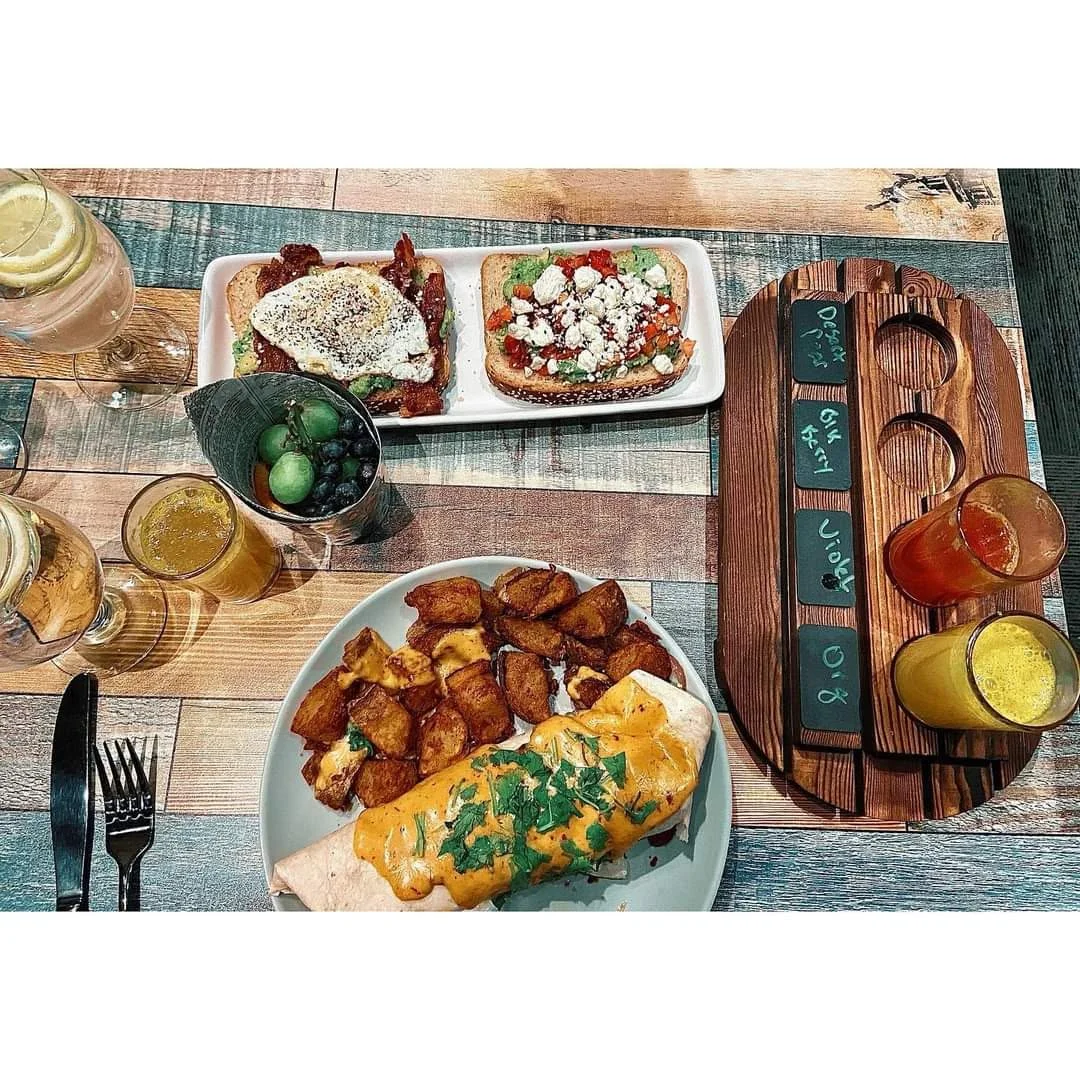 Hearty breakfast burrito with sides in a vibrant restaurant setting