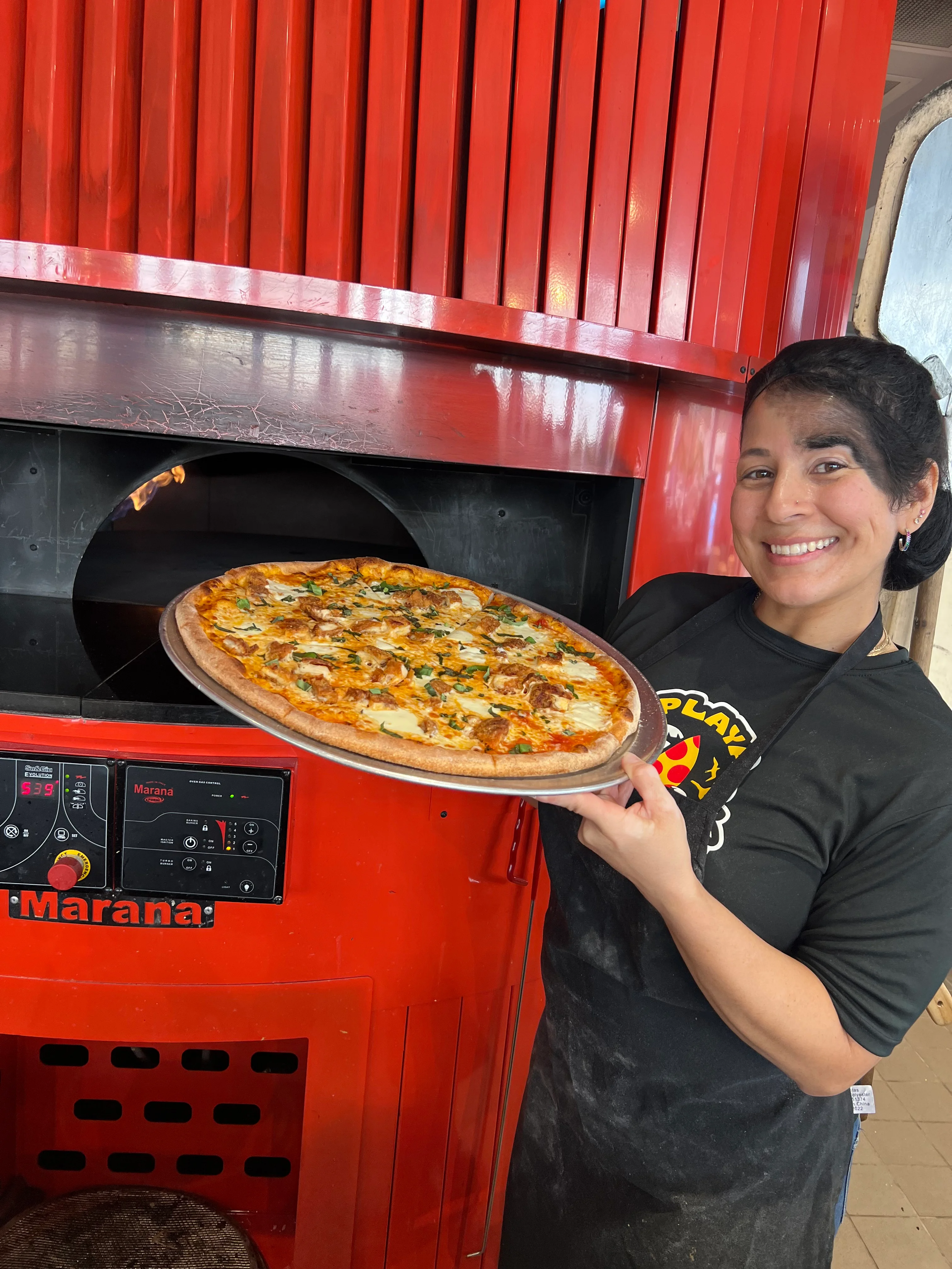 Pizza coming out of the oven