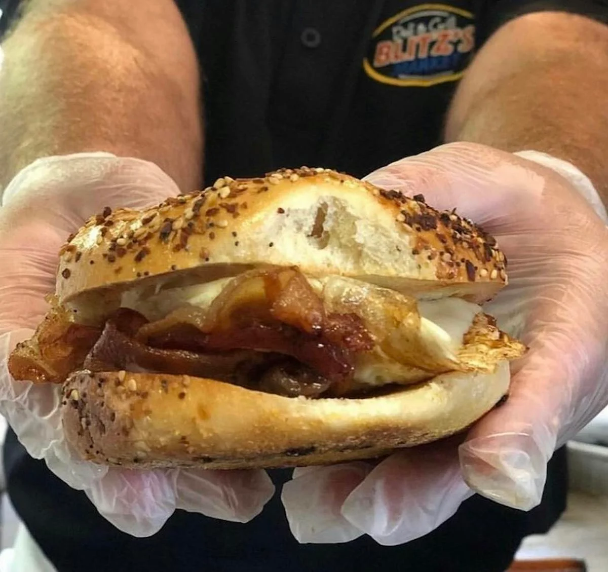 Savory breakfast bagel sandwich with bacon and egg