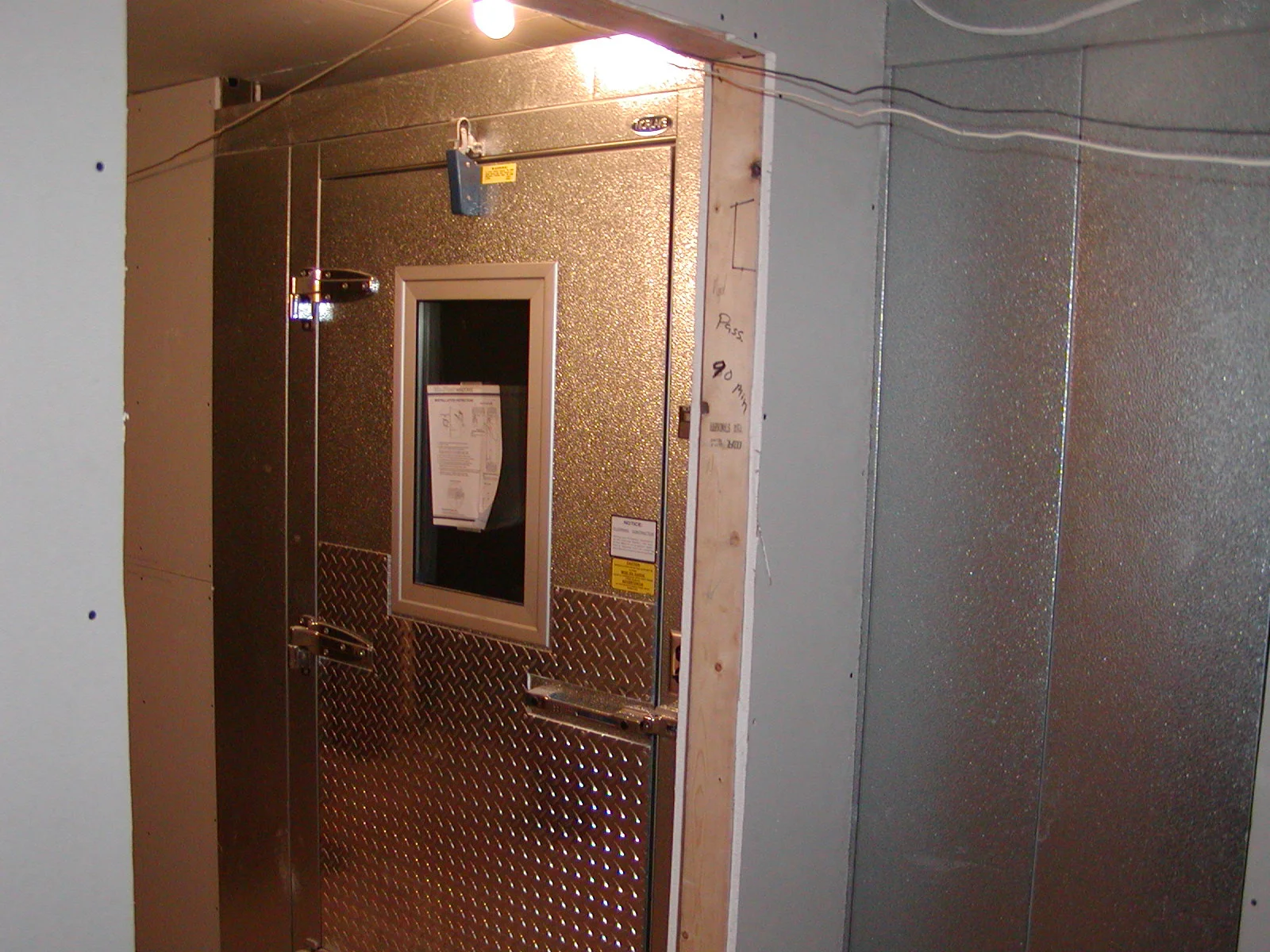 Commercial walk-in cooler entrance with metallic finish