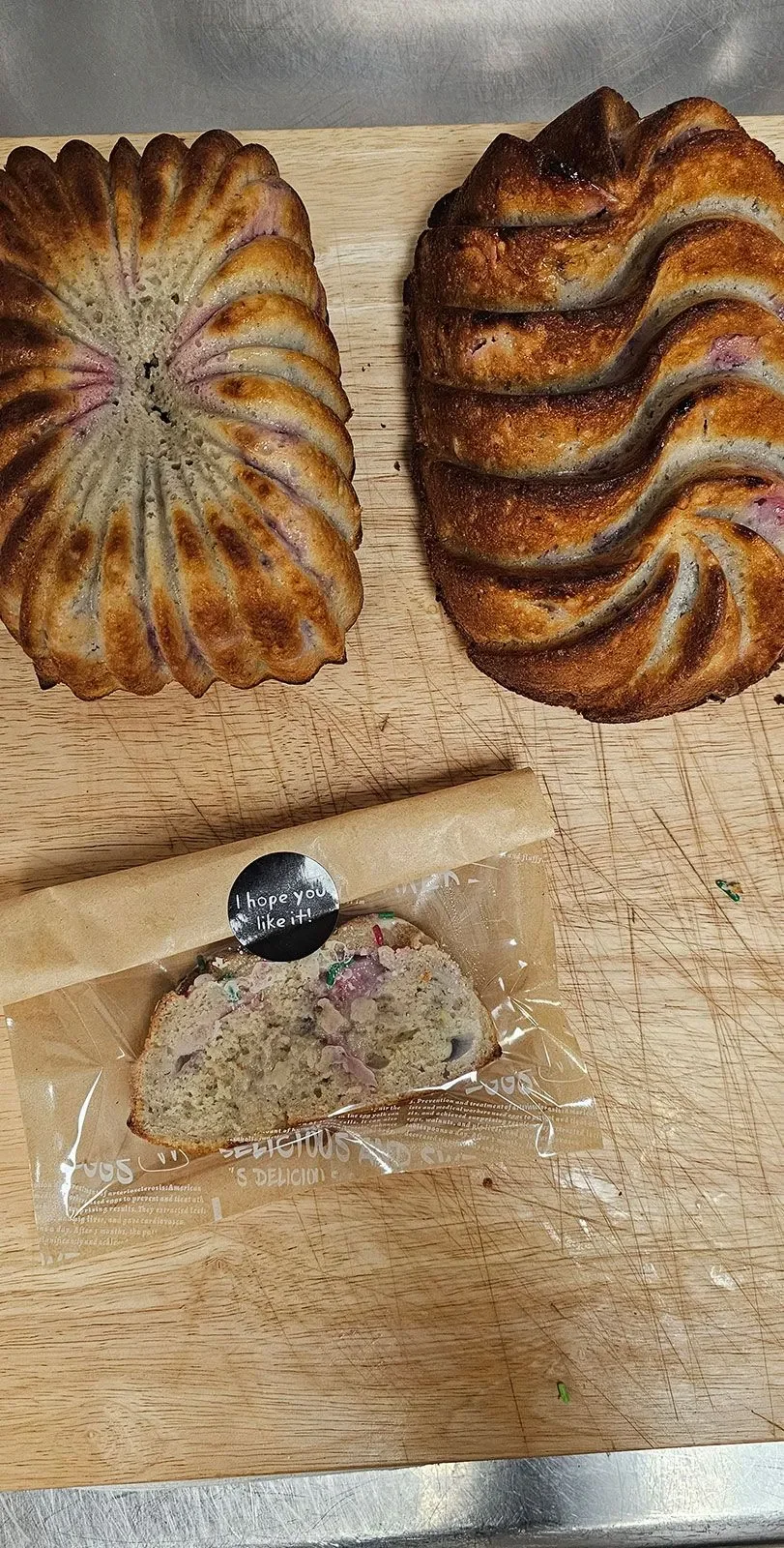 Artisan bread loaves with unique shapes and a slice in packaging