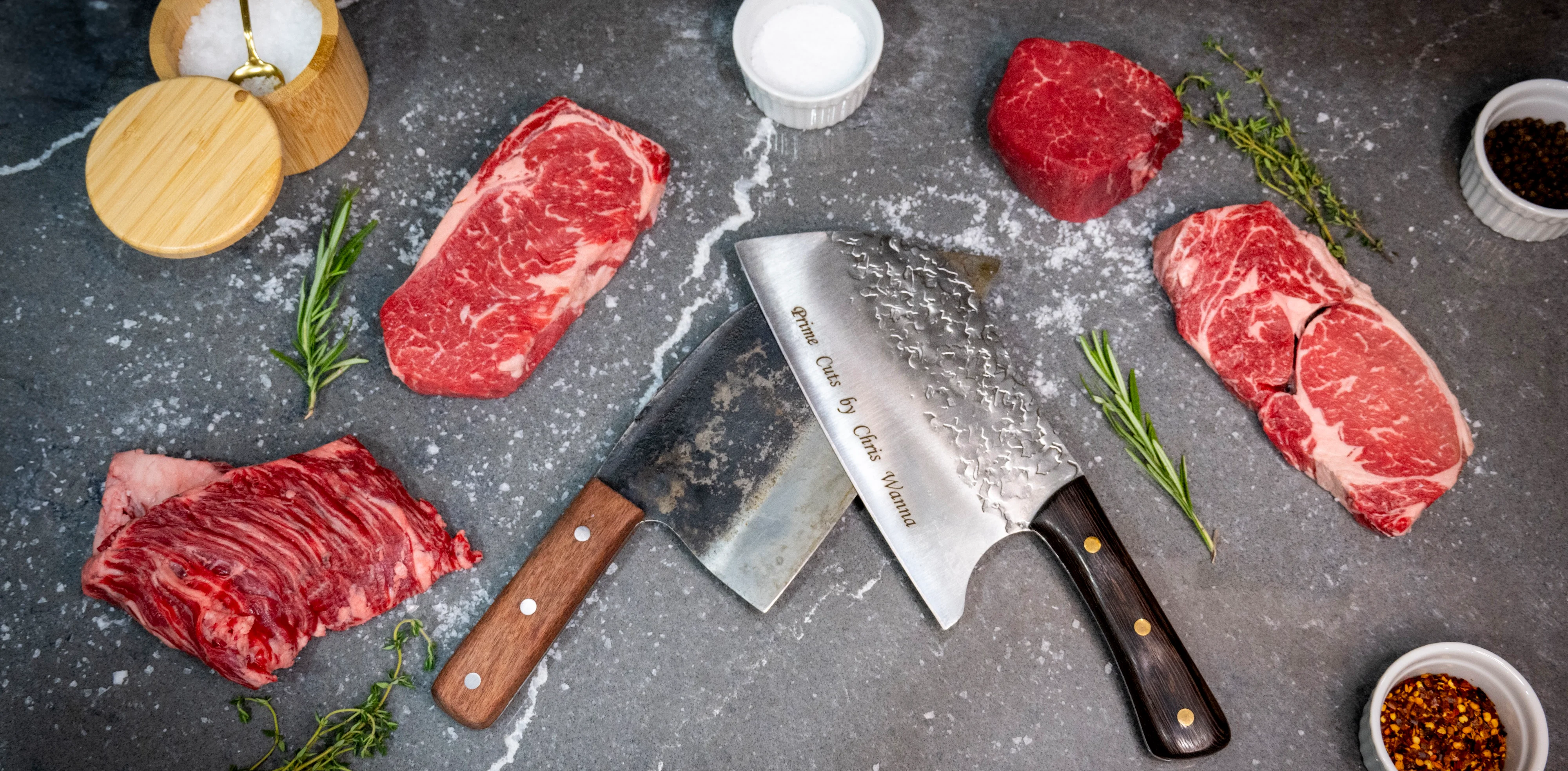 Premium cuts of beef with a chef's knife on a stone surface